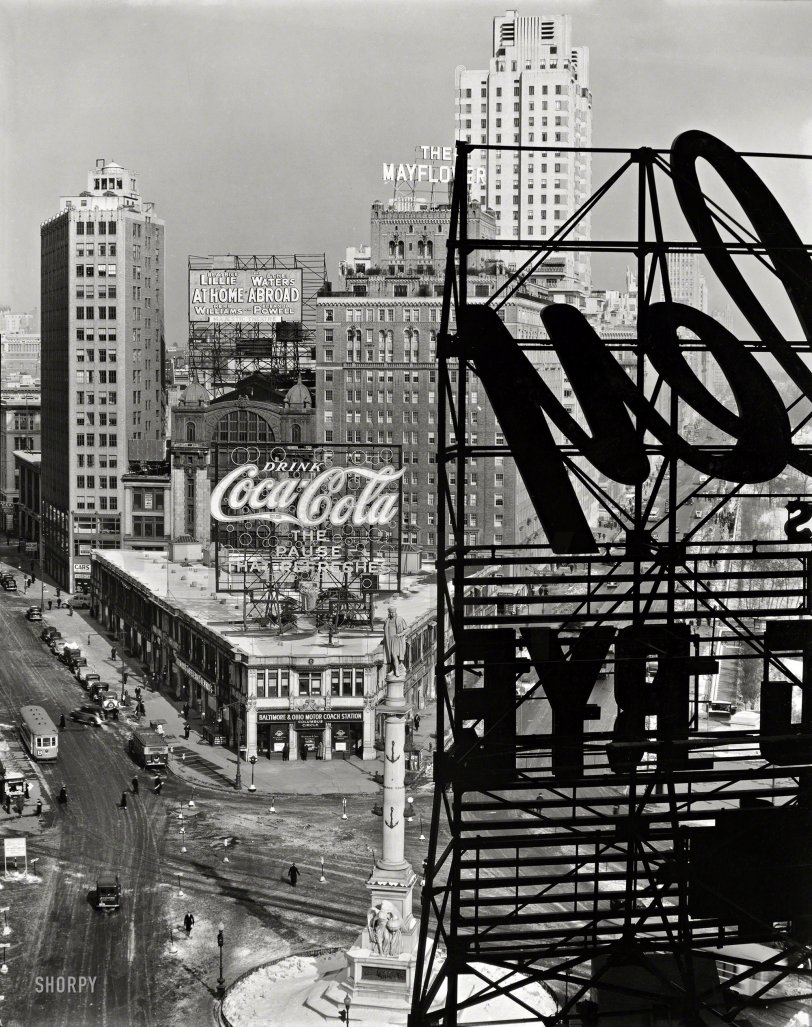 Feb. 10, 1936. "Columbus Circle, Manhattan -- Looking northwest from above the circle, statue of Columbus, B&amp;O bus station topped with Coca-Cola sign, other signs, Mayflower Hotel, Central Park with snow." 8x10 gelatin silver print by Berenice Abbott for the Federal Art Project. View full size.
