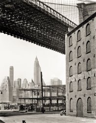 May 22, 1936. "Warehouse district, Water and Dock Streets, Brooklyn, looking west under Brooklyn Bridge to Lower Manhattan." 8x10 gelatin silver print by Berenice Abbott for the Federal Art Project. View full size.