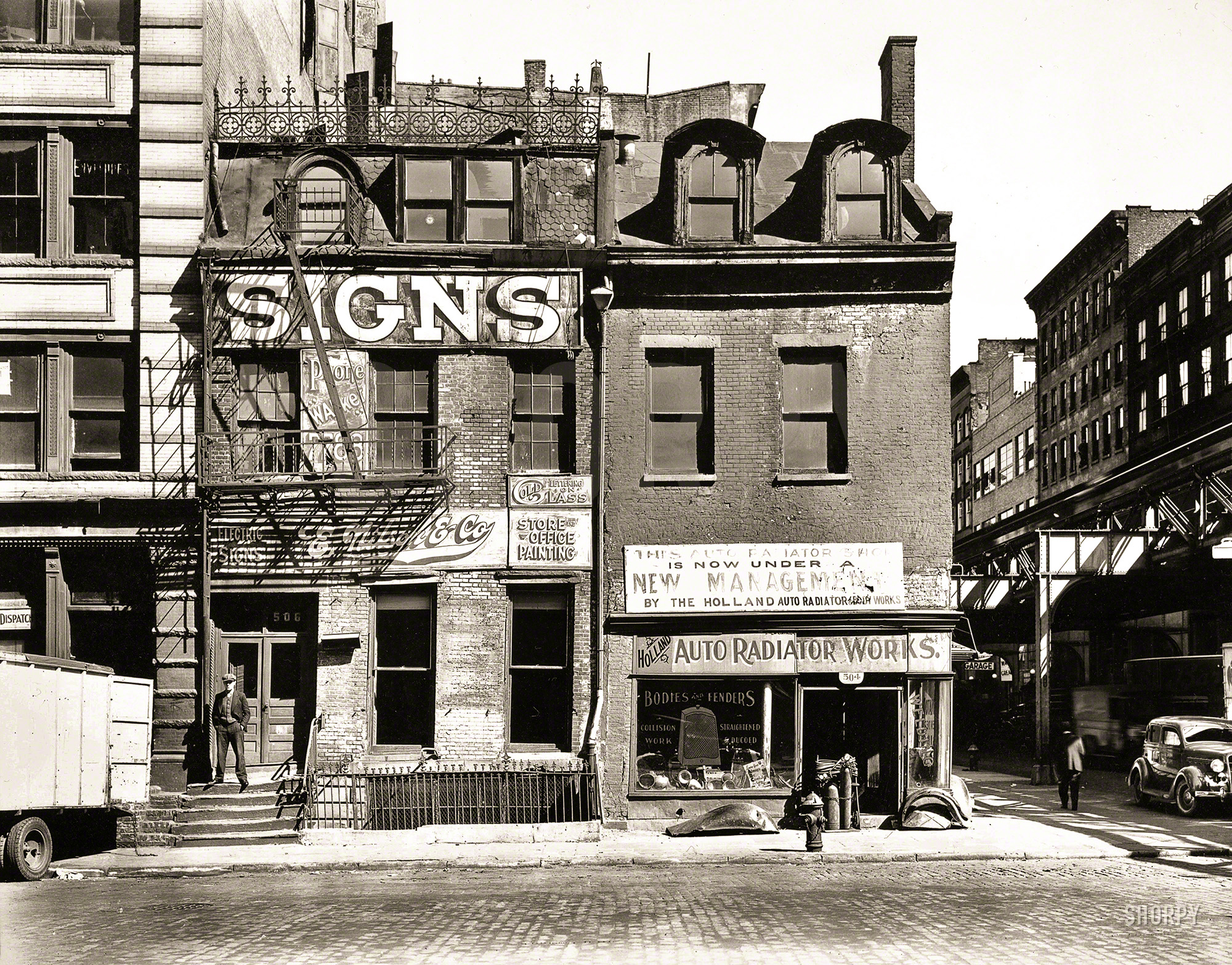 Oct. 9, 1935. "Broome Street, Nos. 504-506, Manhattan." 8x10 inch gelatin silver print by Berenice Abbott for the Federal Art Project. View full size.