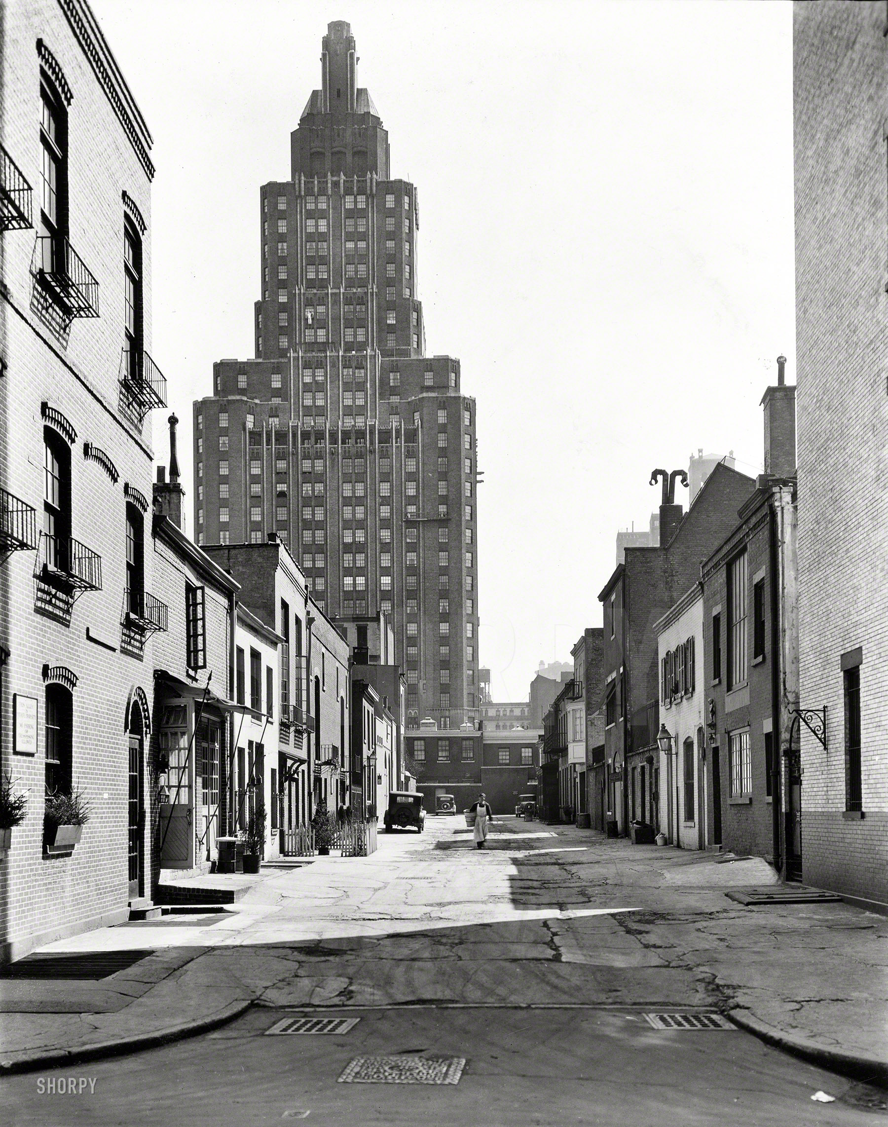 March 20, 1936. "Macdougal Alley, between West 8th Street and Washington Square North, Manhattan. 1 Fifth Avenue rises above." 8x10 gelatin silver print by Berenice Abbott for the Federal Art Project. View full size.