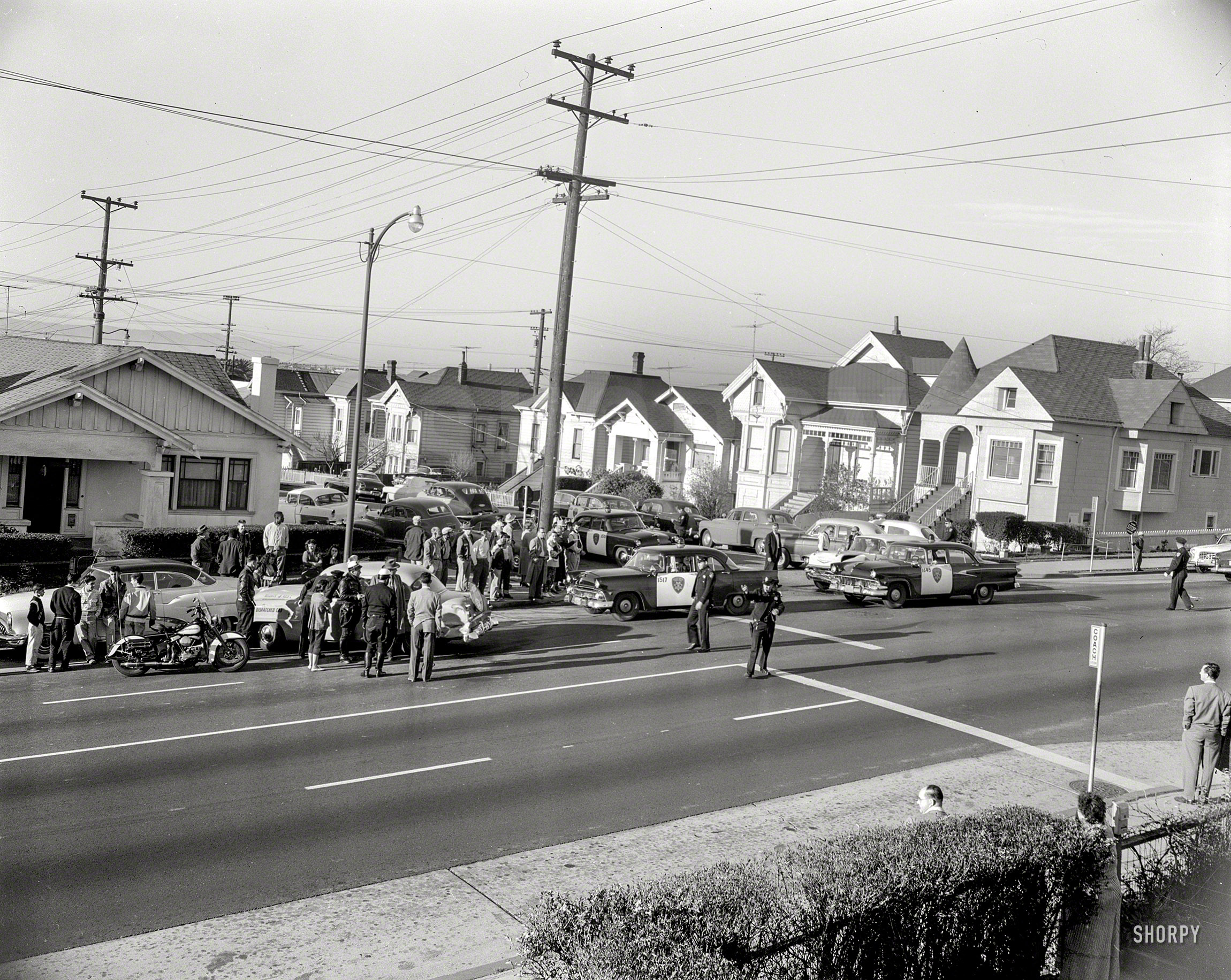 Oakland, Calif., circa 1957. "Wrecked taxi at school crossing." Note the crossing guard at right. Featured players in this curbside drama include a 1957 Chevy, Plymouth taxicab and (yet again) 1953 Buick, supported by a trio of 1955 and '56 Ford police cars. 4x5 acetate negative from the News Archive. View full size.