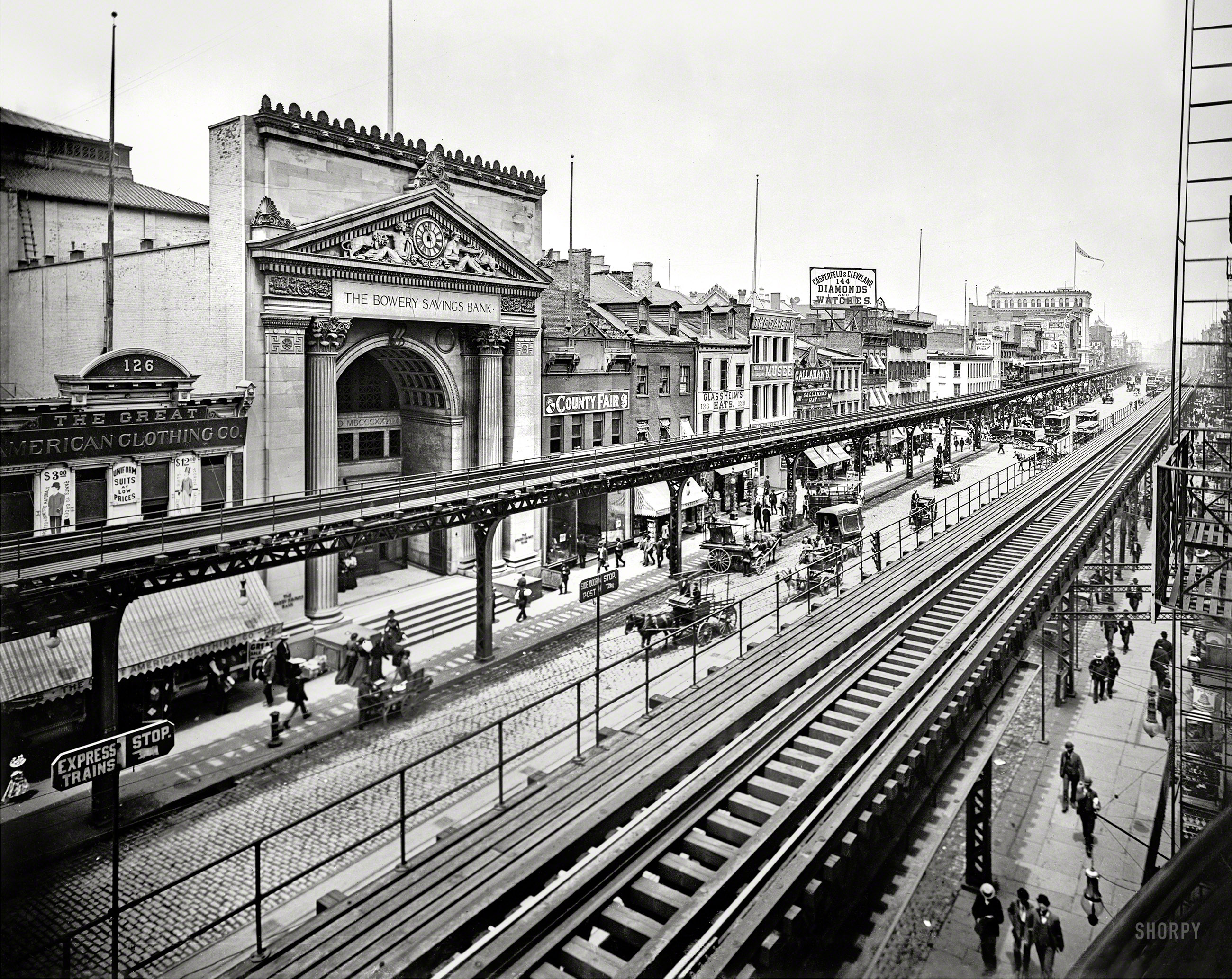 Manhattan circa 1900. "The Bowery, New York." The tracks of the Third Avenue El passing the Bowery Savings Bank. 8x10 inch glass negative. View full size.