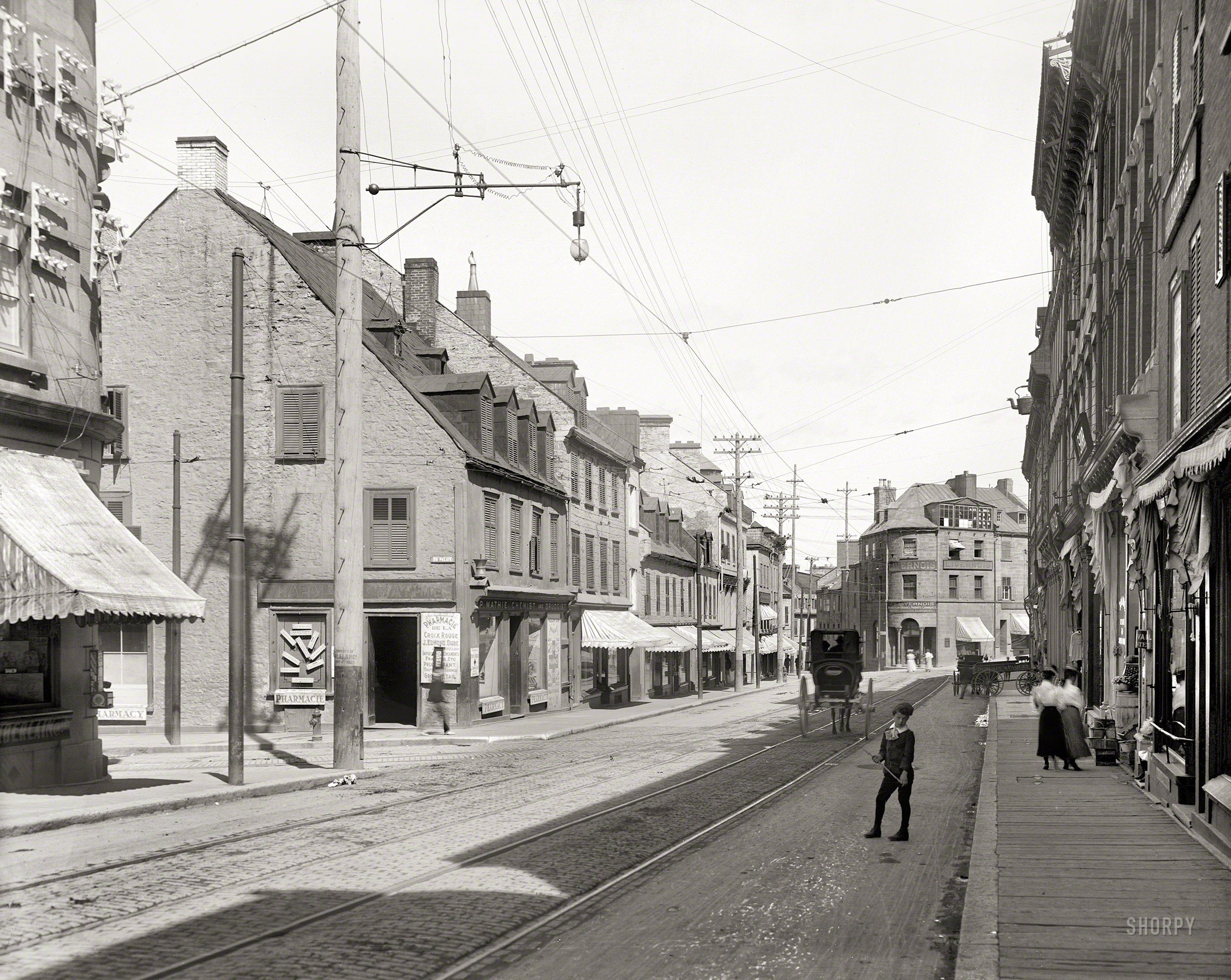 Circa 1905. "St. John Street, Quebec." Rue Saint-Jean at Côte du Palais in Quebec City, home to the drugstores of P. Mathie and J.E. Livernois. 8x10 inch dry plate glass negative, Detroit Photographic Company. View full size.