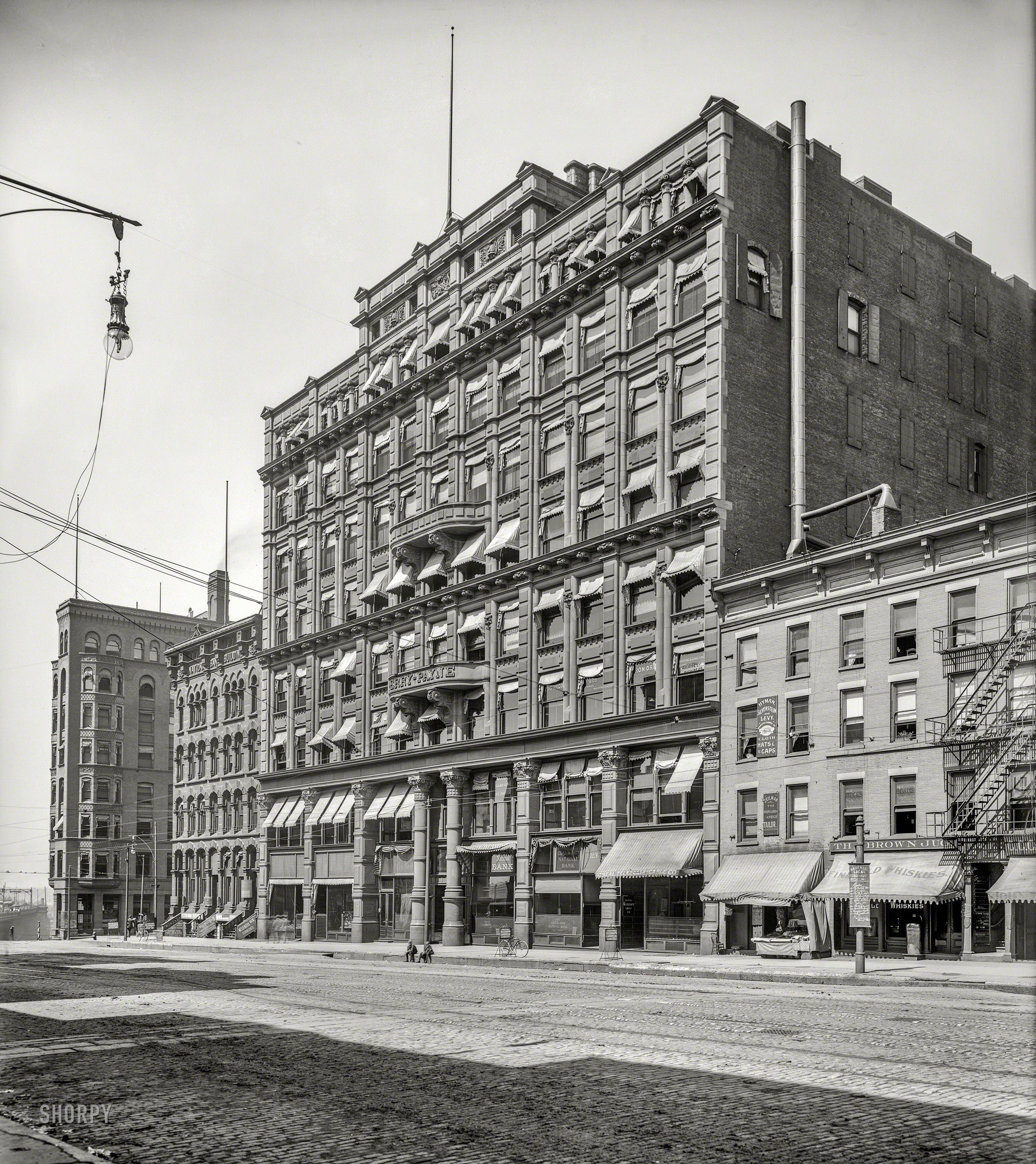 Cleveland circa 1900. "Perry-Payne Building, Superior Avenue." This fine old structure, completed in 1888, survives today as an apartment building; the Brown Jug next door has, alas, evaporated along with its "Fine Old Whiskies." 8x10 inch dry plate glass negative, Detroit Publishing Company. View full size.