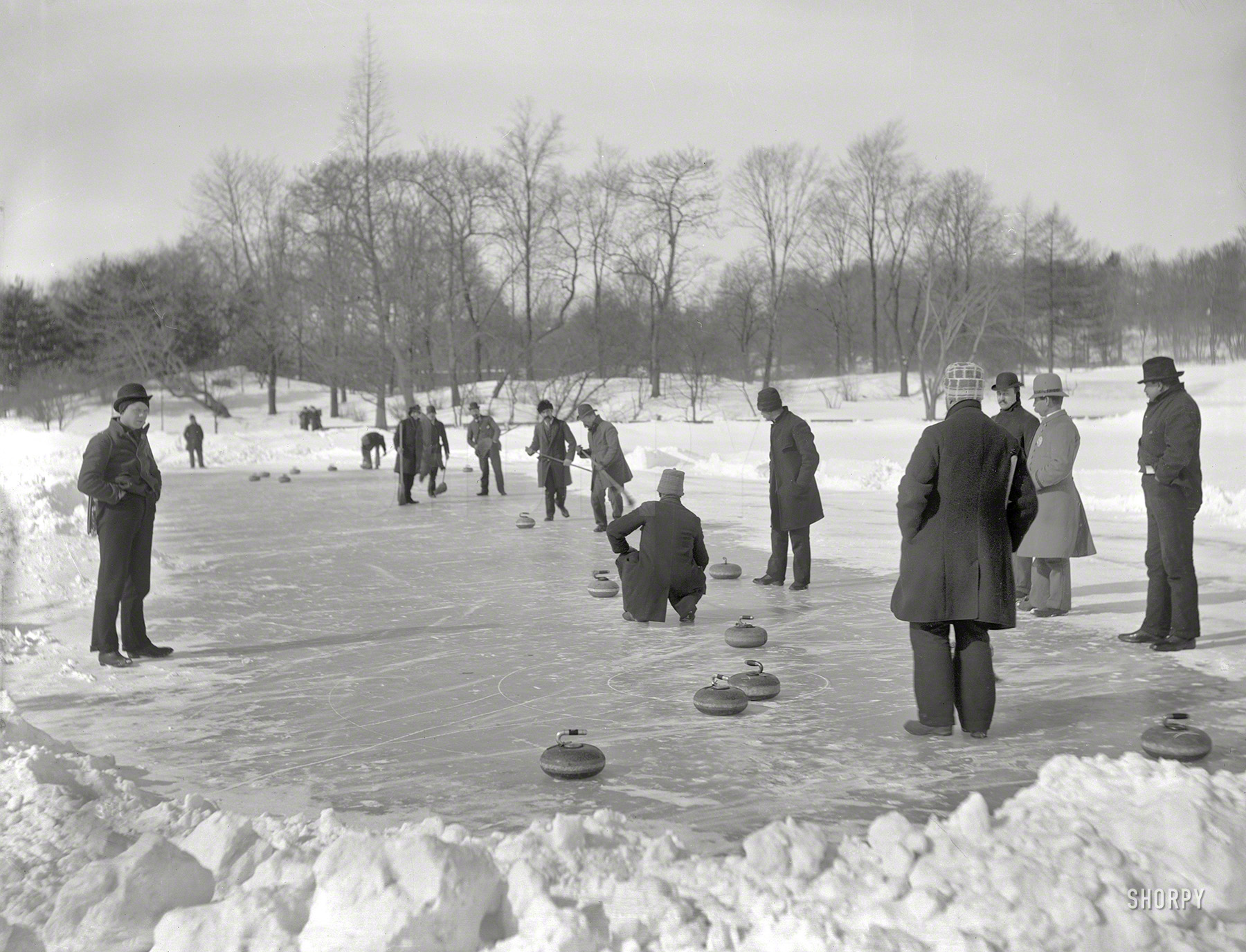 New York circa 1905. "Curling in Central Park." Sighting the curling-cue for a bank shot into the corner pocket. 8x10 inch glass negative by Byron. View full size.