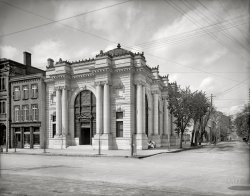 Augusta, Georgia, 1903. "Georgia Railroad Bank, Seventh and Broad Streets." 8x10 inch dry plate glass negative, Detroit Photographic Company. View full size.
My hometownIn "downtown" Augusta, there was a bank on the corner of Seventh and Broad Street from the 1830s until 2015! In 1967, sadly a large (sky scraper) building was erected to replace the beautifully designed bank pictured above. In 2015, Wells Fargo closed its branch (which was housed in the "skyscraper" built in '67). 
In 1916, Augusta had a horrible fire that burned much of the town. However, the bank pictured in 1903 survived. My great grandfather took several photographs of the aftermath of the fire and floods through the years. He was a pediatrician in Augusta. His doctor's office was in the Lamar building on Broad Street. The Lamar building still stands today. I wish we still had the old glass plate negatives from the photographs he took. 
Long historyThe Georgia Railroad and Banking Company (it did both) was chartered way back in the 1830s, making it one of the earliest railroads in the US. Over time the banking side of the business proved to be the more profitable and survived the Civil War and the Depression before eventually being absorbed in a series of mergers beginning in 1986. Today the parent company is Wells Fargo. The railroad also has disappeared in the usual run of corporate mergers, with CSX now controlling what is left of their old lines. 
Homeless bank person?Is that a pioneer homeless fellow between the columns at the corner? Must be one of the first! He has a hat, and bundles, but no shopping cart or tent.
Wonder what his story really is.
[Um, that's a nursemaid with two baby carriages. - Dave]
History of the Bank and Buildingshttps://www.georgiaencyclopedia.org/articles/business-economy/georgia-ra...
I&#039;ll Huff and I&#039;ll PuffBut it's gonna take more than a gust a wind to blow that august Augusta building down!
(The Gallery, DPC, Railroads)