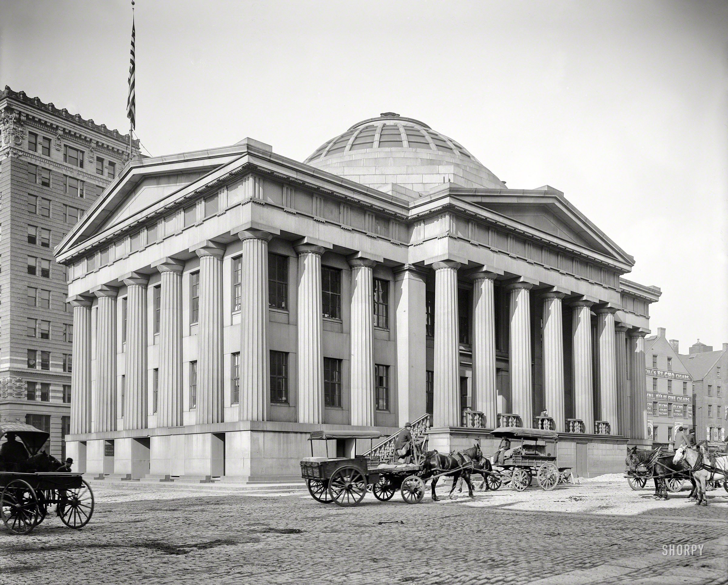 &nbsp; &nbsp; &nbsp; &nbsp; The 1849 Custom House, built at the end of the city docks, was used by the federal government to collect maritime duties in the age of Boston clipper ships. In 1915, after land reclamation had filled in the waterfront, the dome was topped with a 500-foot tower.
Circa 1906. "Custom House -- Boston, Massachusetts." 8x10 inch dry plate glass negative, Detroit Publishing Company. View full size.