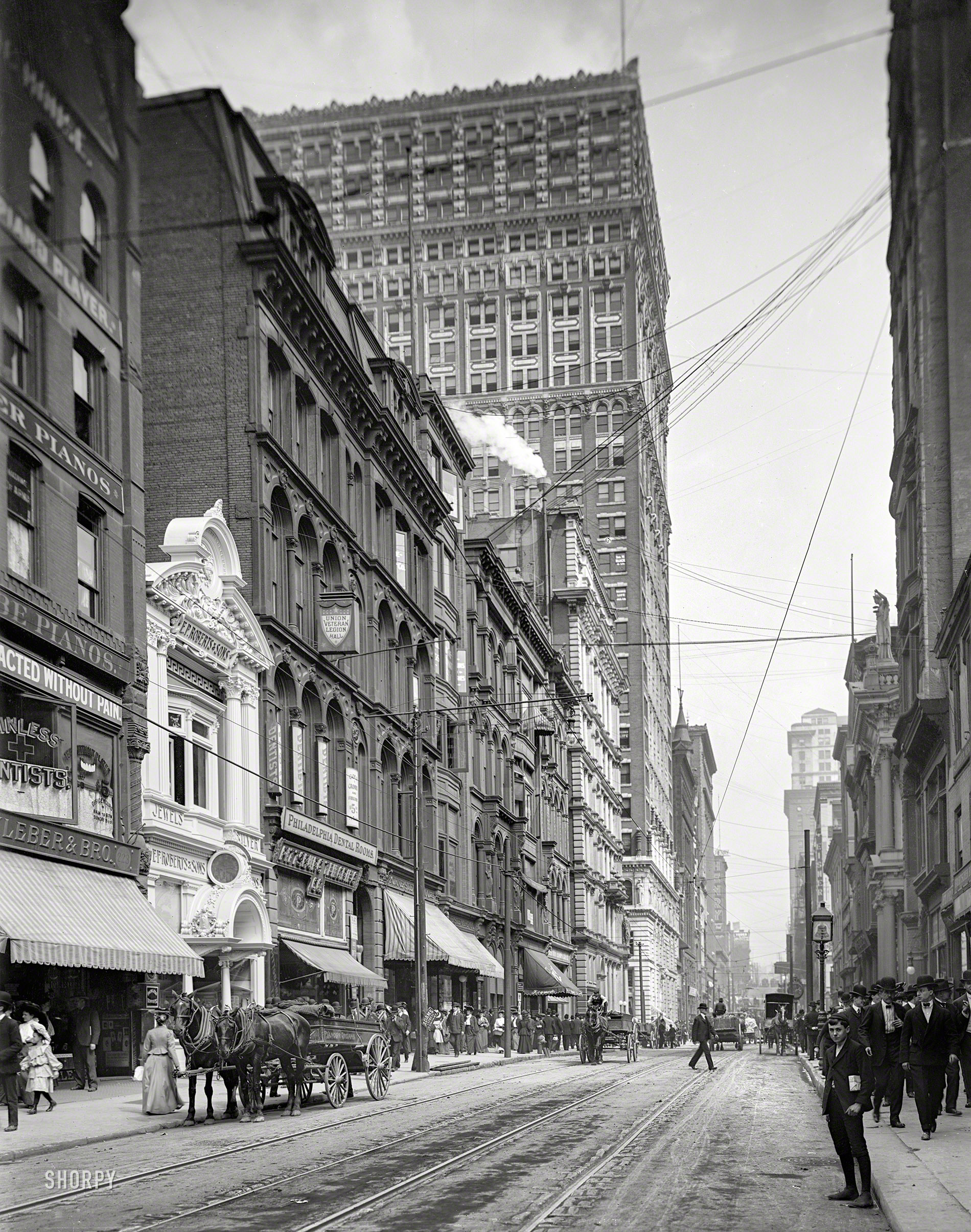 1904. "Fifth Avenue, Pittsburg, Pa." Address of the Philadelphia Dental Rooms, on what seems to have been Pittsburgh's go-to street for Painless Dentistry. Looming over it all is the recently completed Farmers Bank building. View full size.