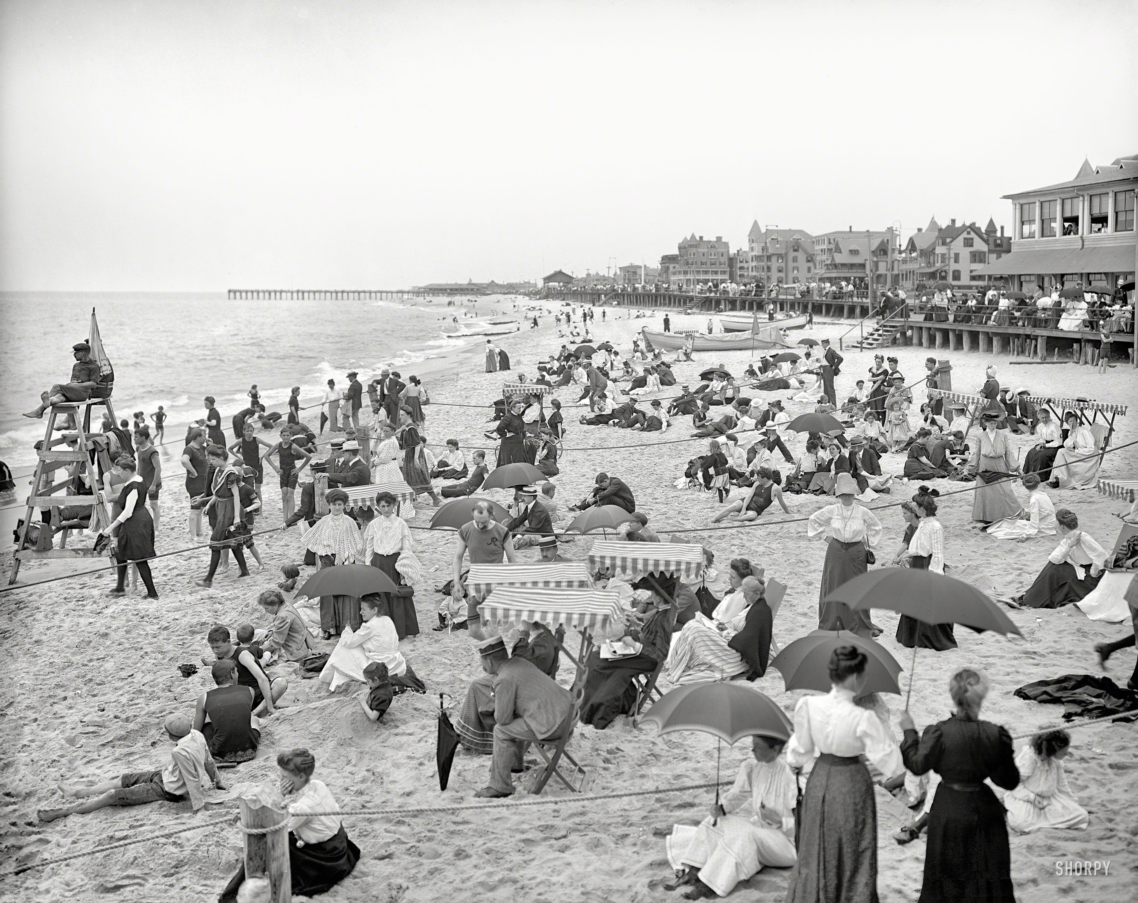 The Jersey shore circa 1905. "On the beach at Ross' pavilion, Ocean Grove, N.J." Short of tuxes and ballgowns, it's hard to imagine being any more dressed up at the beach. (And cheer up, guy in the middle -- your problems are over by now.) 8x10 inch dry plate glass negative, Detroit Publishing Company. View full size.