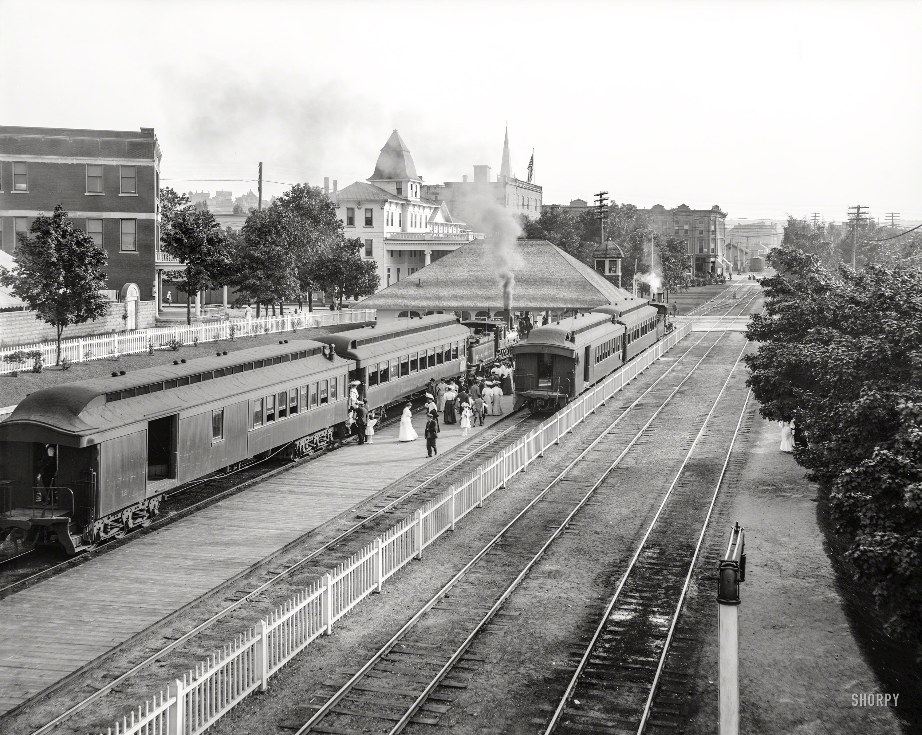Circa 1906. "Suburban station at Petoskey, Michigan." A locomotive of the Grand Rapids & Indiana Railroad, with a car bearing the names of Little Traverse Bay and Crooked and Walloon Lakes. 8x10 inch glass negative. View full size.