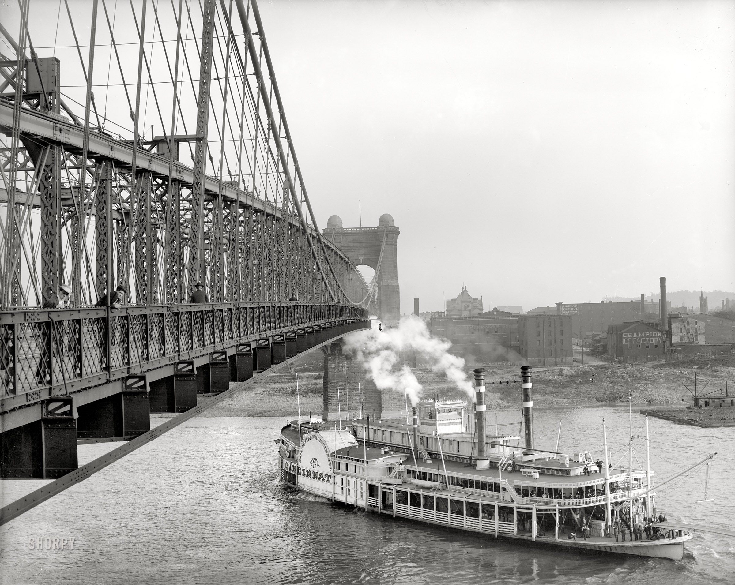 Cincinnati, Ohio, circa 1906. The sidewheeler Cincinnati passing under the Roebling Suspension Bridge. Detroit Publishing glass negative. View full size.