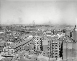 1906. "Looking east, Boston, Mass." Showing Boston Harbor and, at lower left, historic Faneuil Hall. Our title comes from the grocery next door and its finger-pointing signage. 8x10 inch dry plate glass negative. View full size.