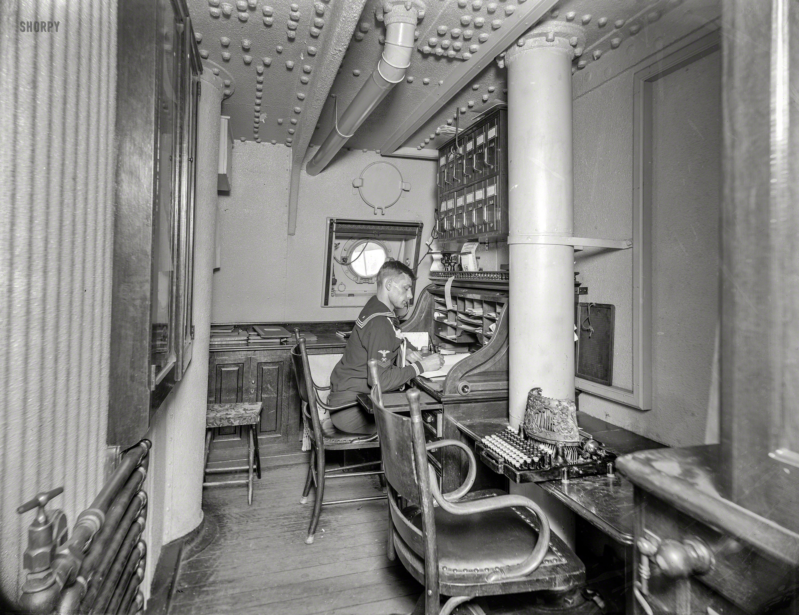 March 16, 1897. "U.S.S. Brooklyn, office of executive officer." Note the ancient typewriter. 8x10 inch glass negative, Detroit Photographic Co. View full size.