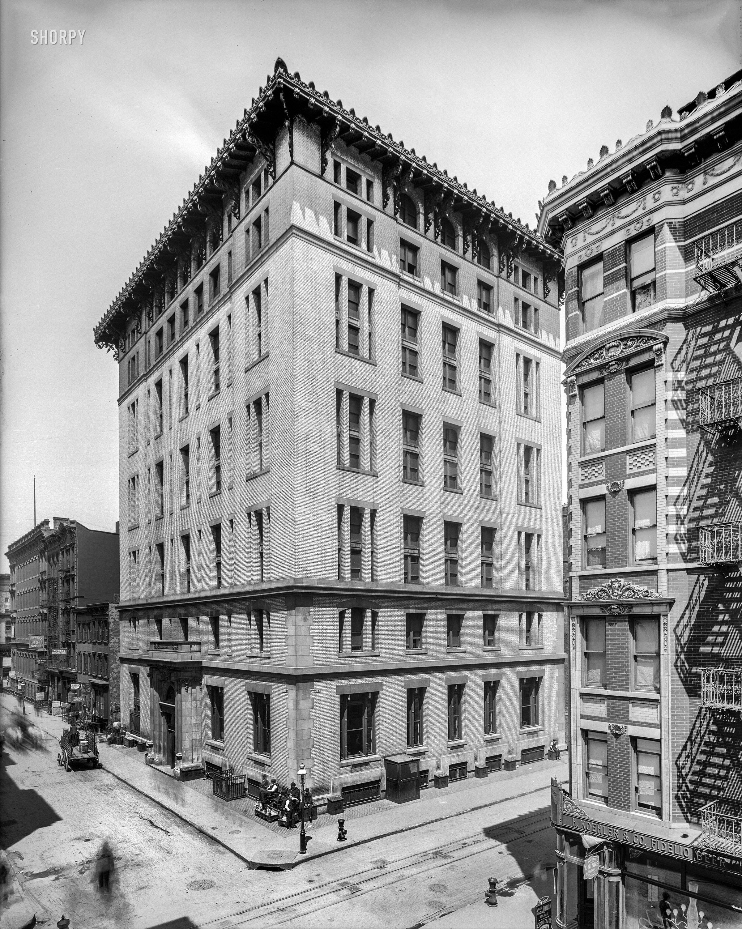 "Mills House No. 2, Rivington Street, New York, N.Y." This "hostel for poor gentlemen," one of three erected by the banker Darius Ogden Mills as lodging houses for working-class men, contained 600 small rooms that rented for 20 cents a day. Our title honors the several ectoplasmic pedestrians whose shades inhabit this time exposure. 8x10 glass negative, Detroit Publishing Co. View full size.