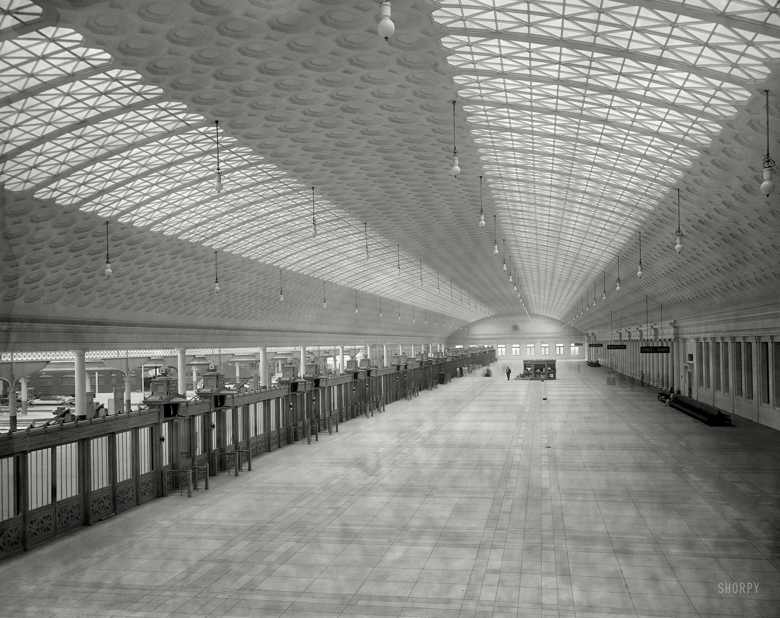 Circa 1910. "Train concourse, Union Station, Washington, D.C." Time exposure capturing hundreds of ephemeral footfalls. 8x10 glass negative. View full size.