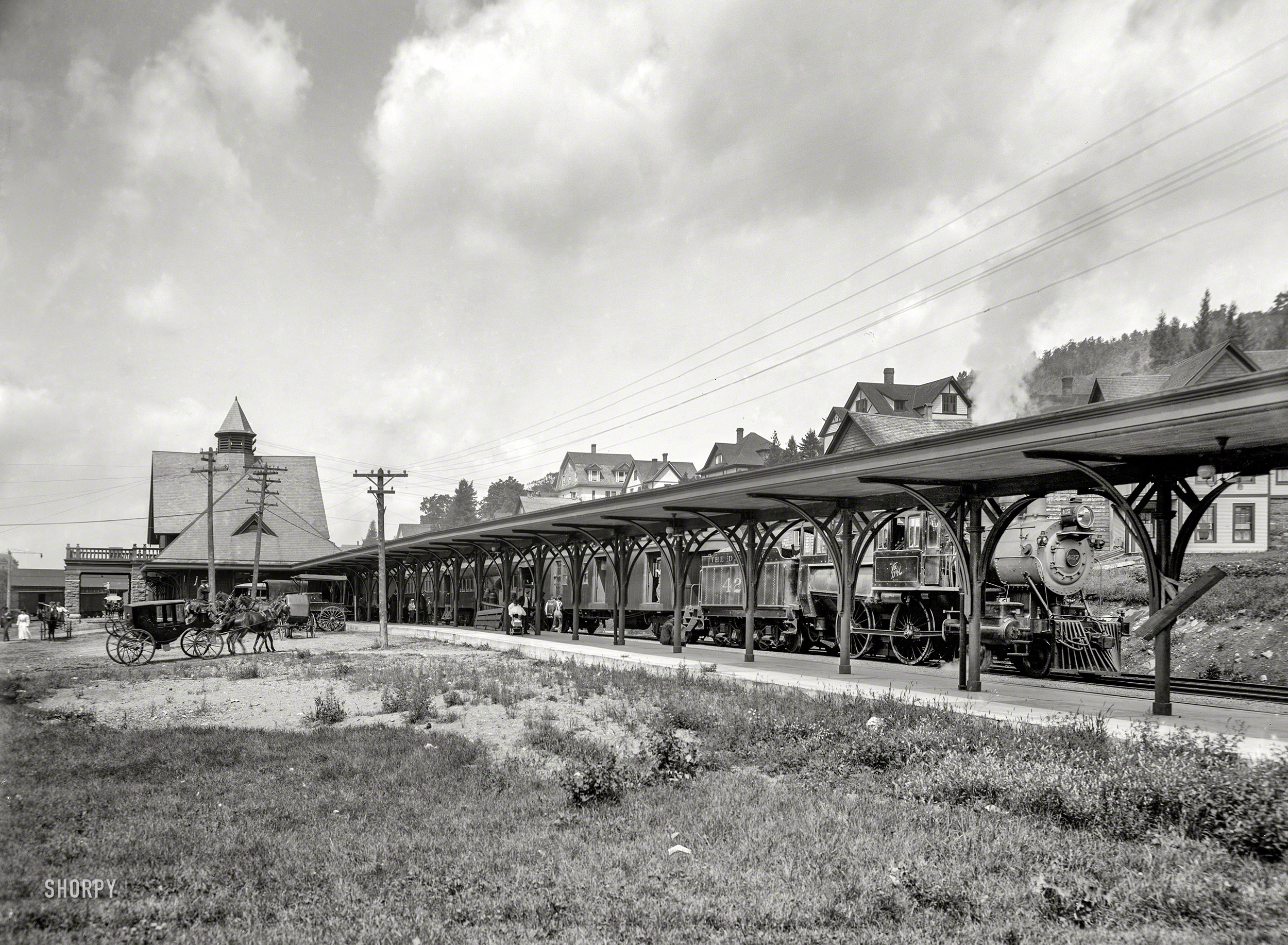 Circa 1905. "Saranac Lake central station, Adirondacks, N.Y." With a locomotive of the Delaware & Hudson Railway. 8x10 inch glass negative. View full size.