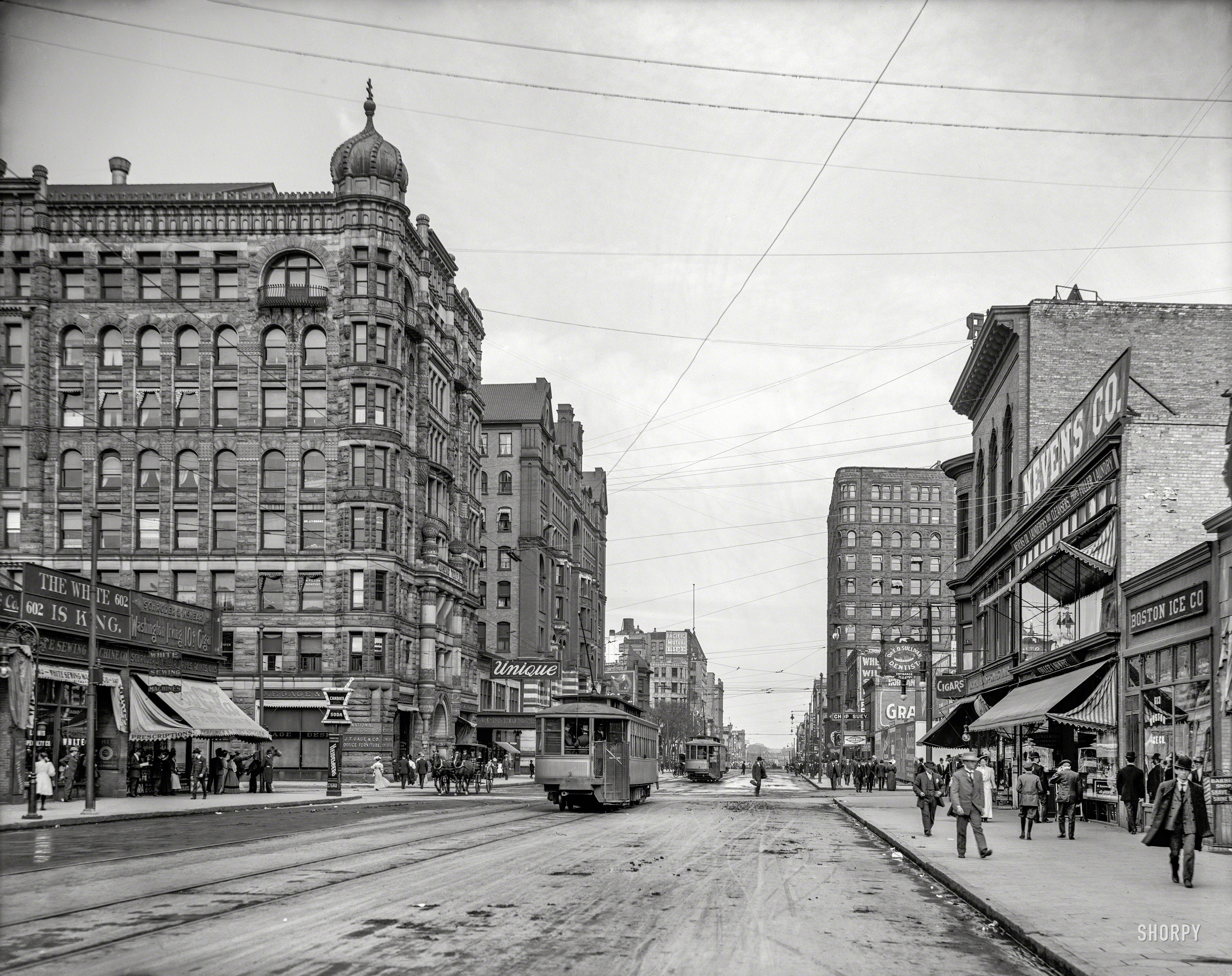 Circa 1908. "Hennepin Avenue, Minneapolis." Our title comes from the sign over the White Sewing Machine Co. store. 8x10 inch glass negative. View full size.