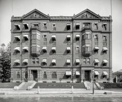 1908. "Rockingham Hotel, Portsmouth, New Hampshire." 8x10 inch dry plate glass negative, Detroit Publishing Company. View full size.
The LibraryMy husband and I have been inside this building many times. On the first floor, to the right is a wonderful (but expensive) restaurant called the Library.  They specialize in meat. I guess they found their niche since every other eatery in Portsmouth caters to seafood lovers.  
The library has been there a long time. The walls are lined with books that you can look at while you eat.  They also bring your check inside of a book.  It's a fun place.
Still a beauty!View Larger Map
Lord RockinghamI wonder if that is the Marquess himself in the left pediment.
[It's Woodbury Langdon. The other bust is Frank Jones. -tterrace]
PerspectiveExcellent perspective correction by lens shifting. Note how the lines do not converge, unlike the Google Streetview image in another comment.
Falling backwardsYep, that's the place, falling backwards because of perspective distortion. Makes you look at old straight buildings with new respect considering the skill it took to make them straight.
By the way, there are other faces in the center horizontal line of the building as well, which Wikipedia didn't cover. Can anyone figure out who *they* are? One may be a cherub (far left) but the others?
["The Four Seasons of Man." -tterrace]
(The Gallery, DPC)