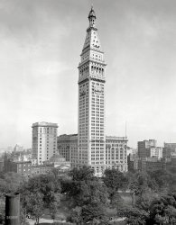 New York in 1909. "Metropolitan Life Insurance Building and Madison Square." The Met Life tower in the final stages of construction, with various scaffolds and platforms attached. 8x10 glass negative, Detroit Publishing Co. View full size.
Prestige over efficiency It looks like the skinny tower part is more for height and prestige than practicality and business efficiency. They could have gotten more useful floor space per dollar building fewer but wider floors. Inadequate space per floor is what doomed the Singer Building.  
Like ClockworkThere appears to be scaffolding of some sort across the clocks. It's too early in the 20th Century for a Daylight Savings Time change. Perhaps some other sort of timepiece maintenance is happening. Too bad we can't see the clocks on the south and east sides of the building.
[Note the absence of hands on the clocks. -tterrace]
(The Gallery, DPC, NYC)