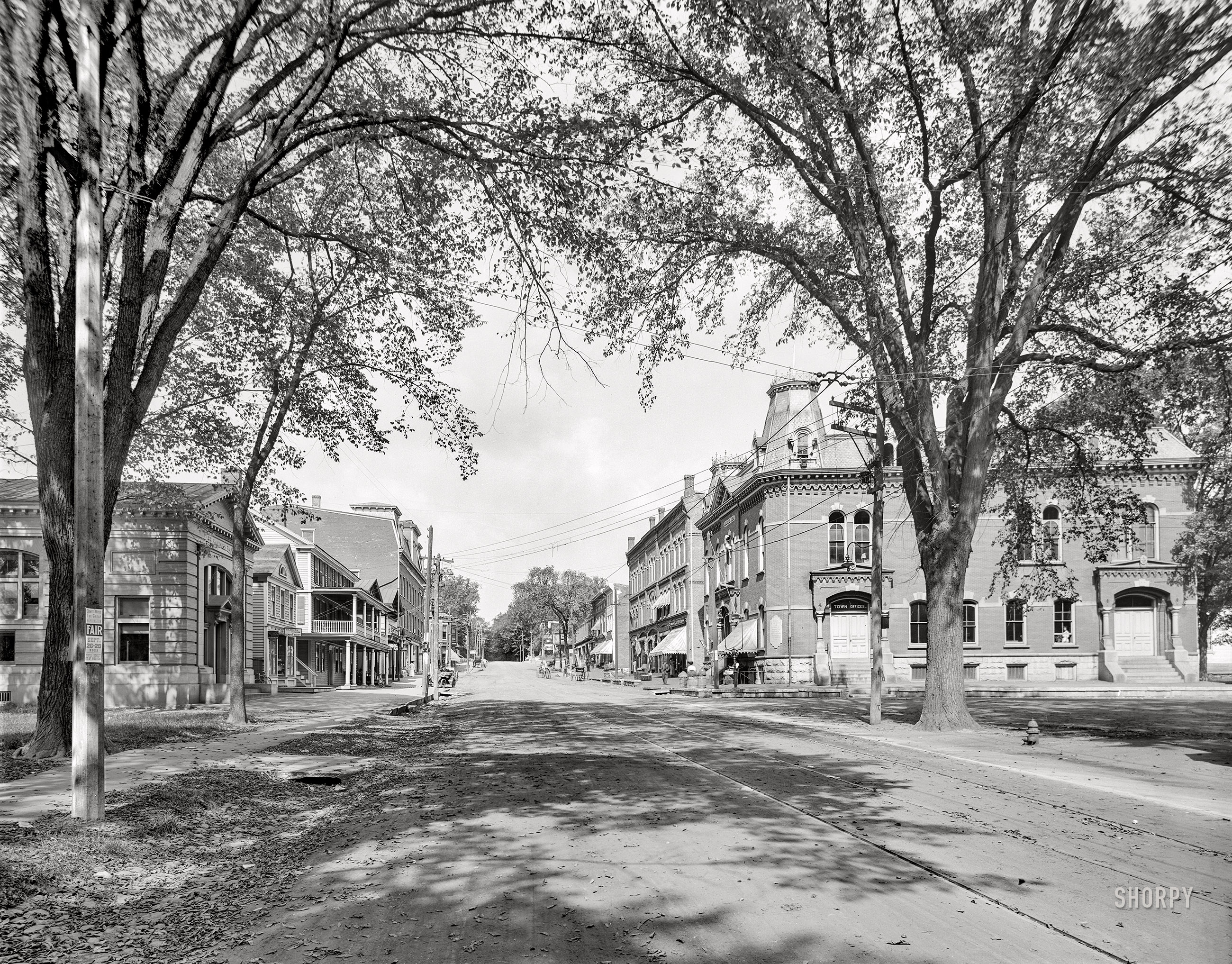 &nbsp; &nbsp; &nbsp; &nbsp; We missed it, and we regret it.
Fall 1911. "The village street -- Lee, Massachusetts." Our title comes from the handbill posted at left. 8x10 inch dry plate glass negative, Detroit Publishing Company. View full size.