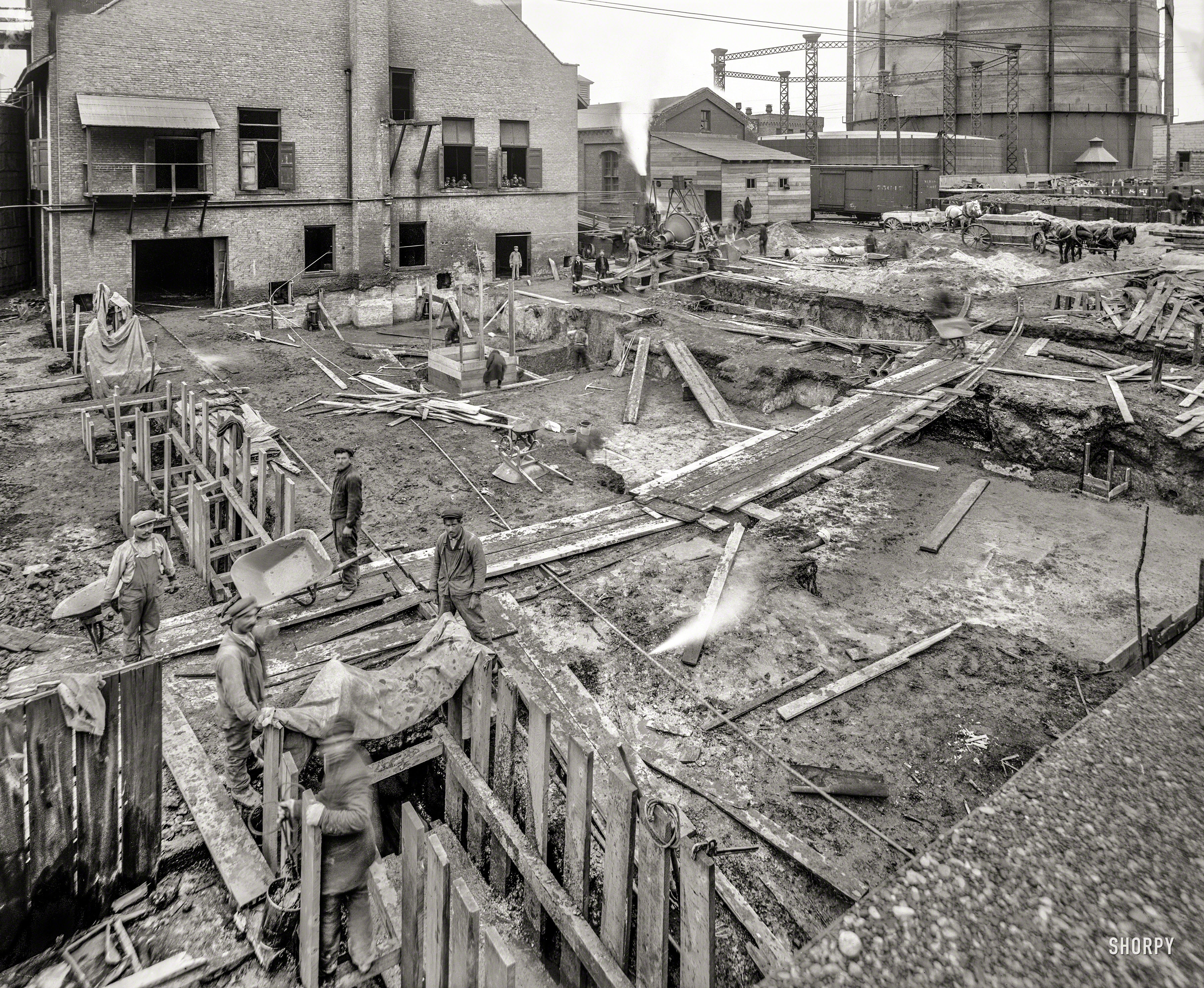 Circa 1912. "Foundation for retort house, construction for Detroit City Gas Company." A scene from the days when most big municipalities had an illuminating-gas plant where coal was heated to make the poisonous product known as "city gas." 8x10 inch glass negative. View full size.
