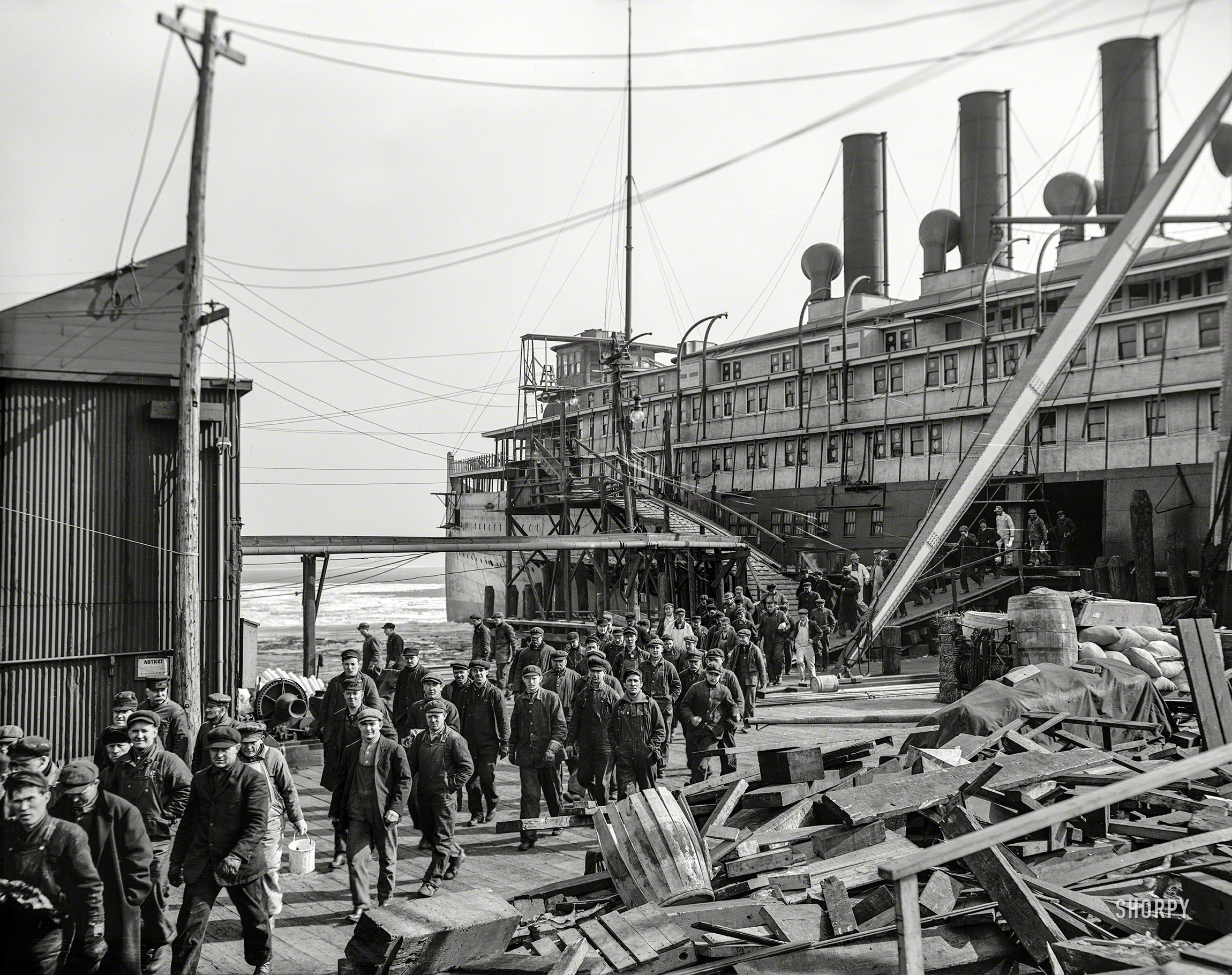 February 14, 1913. "Noon -- Steamer Seeandbee." Lunch break for men working on the sidewheeler Seeandbee at the Detroit Ship Building yard in Wyandotte. View full size.