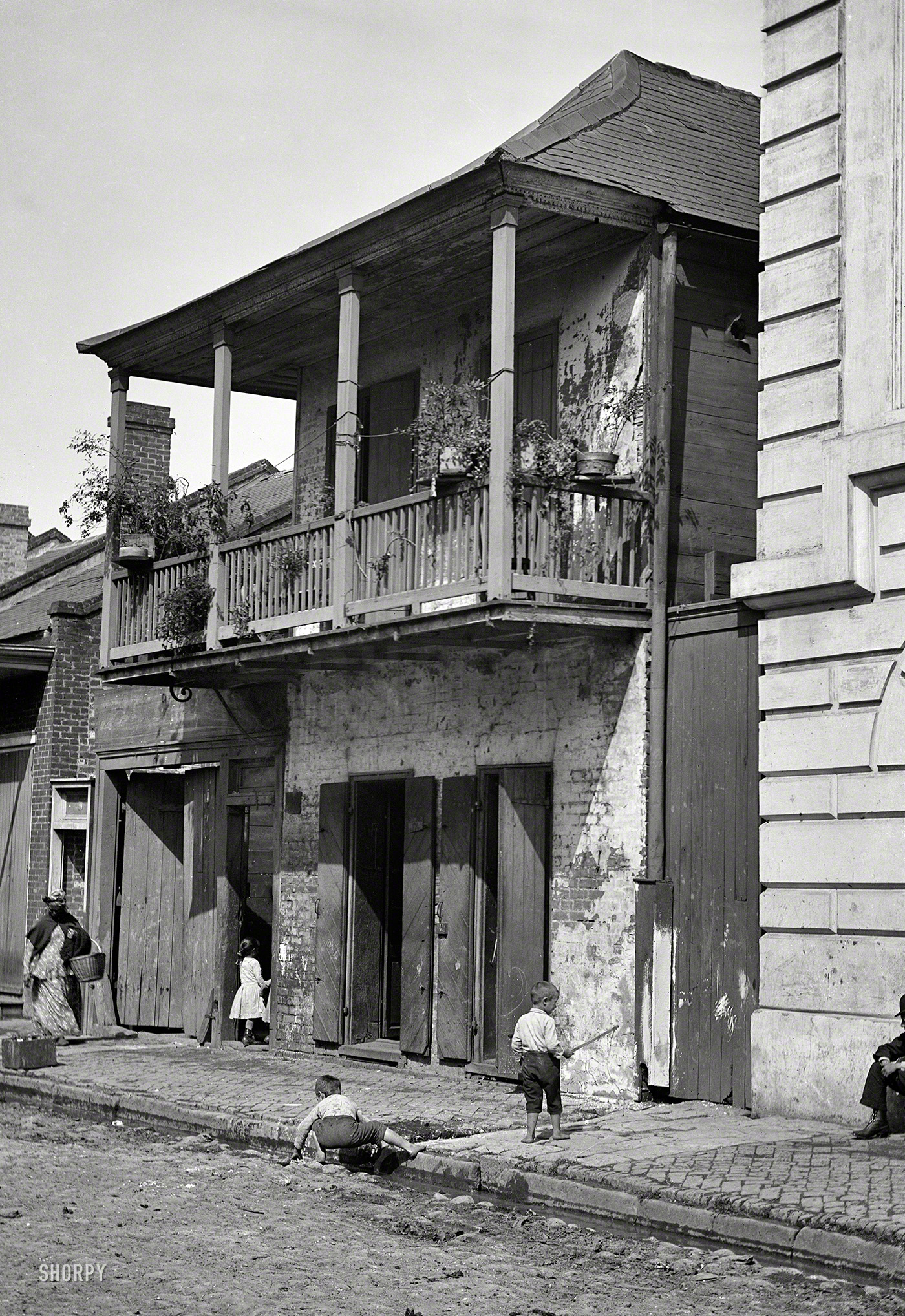 New Orleans circa 1880s-1890s. "Street in the French Quarter." Take care not to trip on the guttersnipes. 5x7 glass negative by William Henry Jackson. Attribution based on Catalogue of the W.H. Jackson Views (1898). View full size.