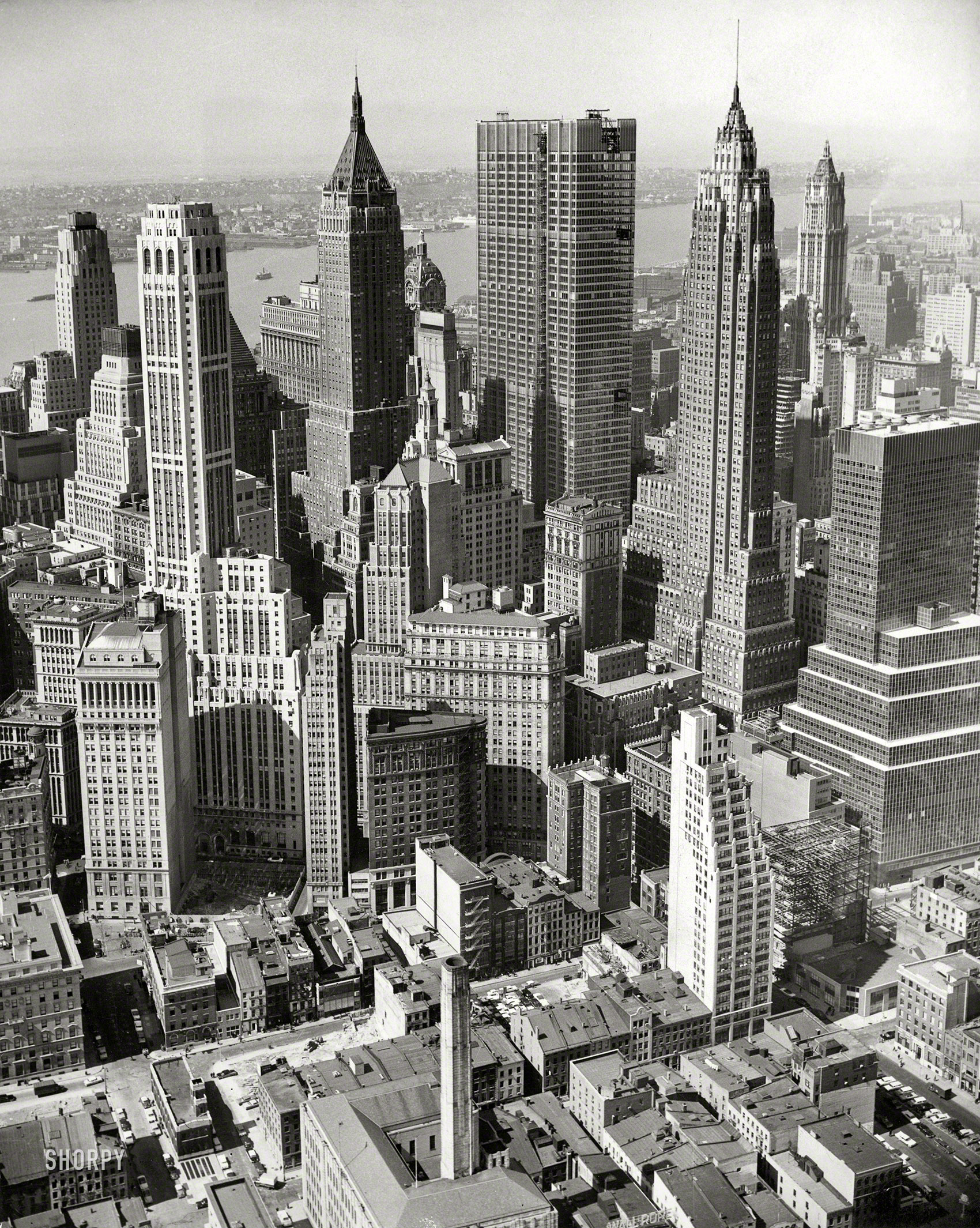 April 15, 1960. "New York City skyline, aerial view of Financial District. Chase Manhattan headquarters under construction." Photo by Al Ravenna for the New York World-Telegram & Sun. View full size.