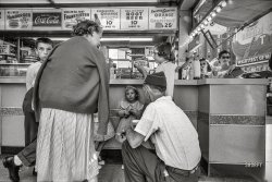 New York City. 1958. "People gathered at lunch counter." 35mm negative by street photographer Angelo Rizzuto (1906-1967), a.k.a. Anthony Angel. View full size.
