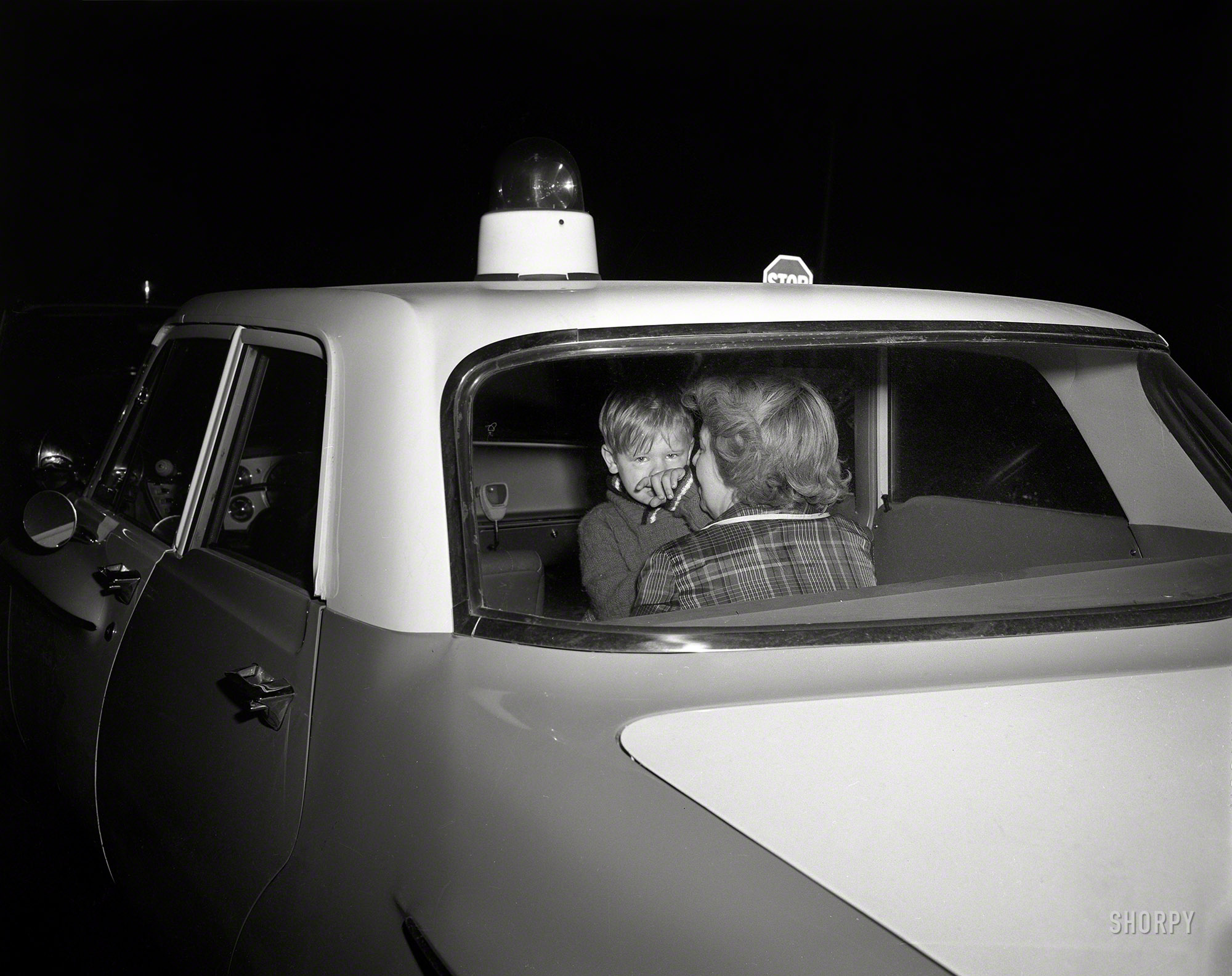 From circa 1962 Chicago comes this uncaptioned shot of a tot in a cop car, caught in the literal glare of publicity. Hopefully the past fifty-odd years have made things all better. 4x5 acetate negative from the News Photo Archive. View full size.