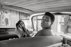Miami, Florida, circa 1960. "Prizefighter (and Olympic gold medalist) Cassius Clay in his Cadillac, which is equipped with a phonograph player." View full size.