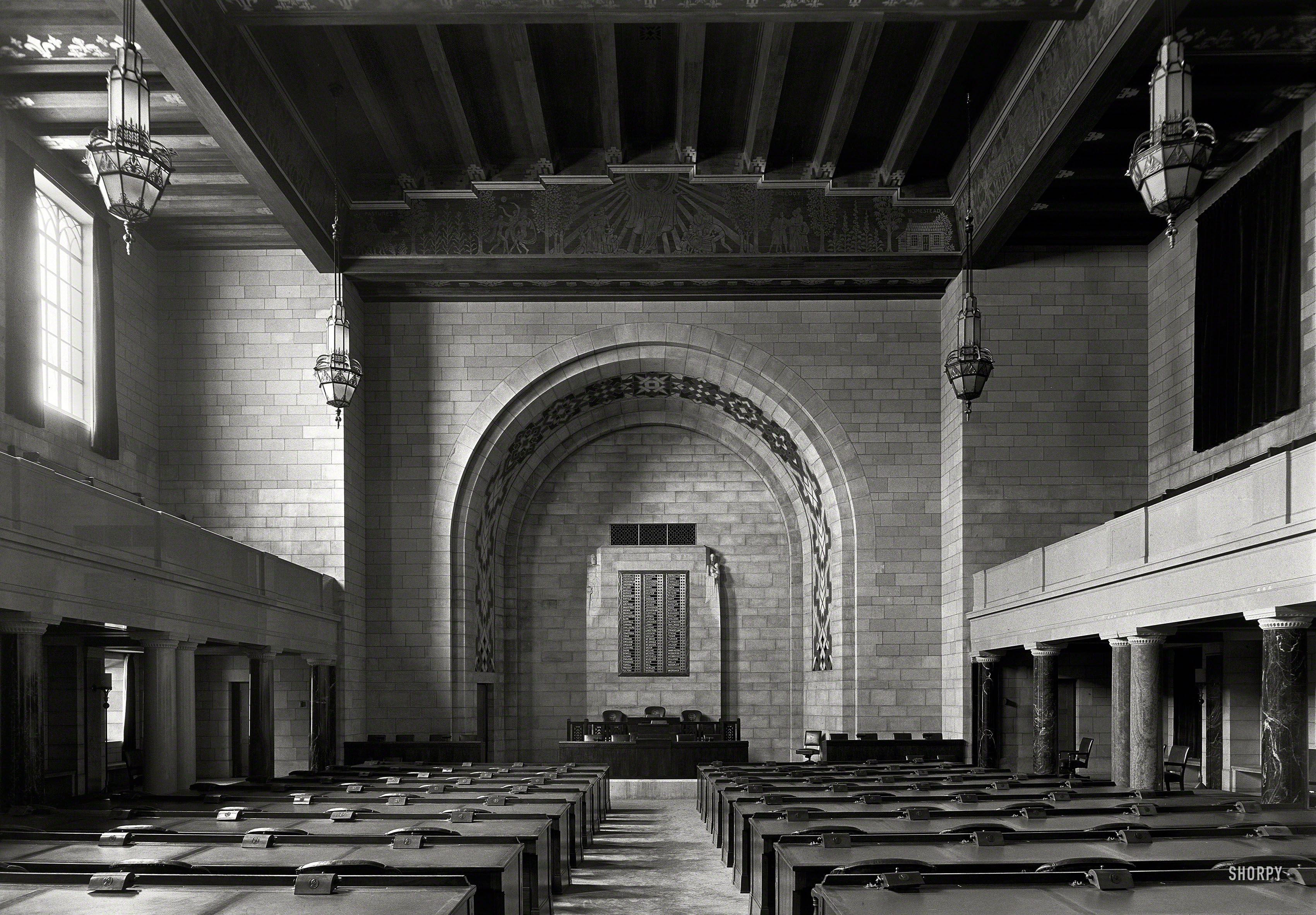 June 1934. "Nebraska State Capitol at Lincoln. House chamber." Note the electro-mechanical tally board, and voting controls decorated with medallions of Abraham Lincoln. Large-format negative by Gottscho-Schleisner. View full size.