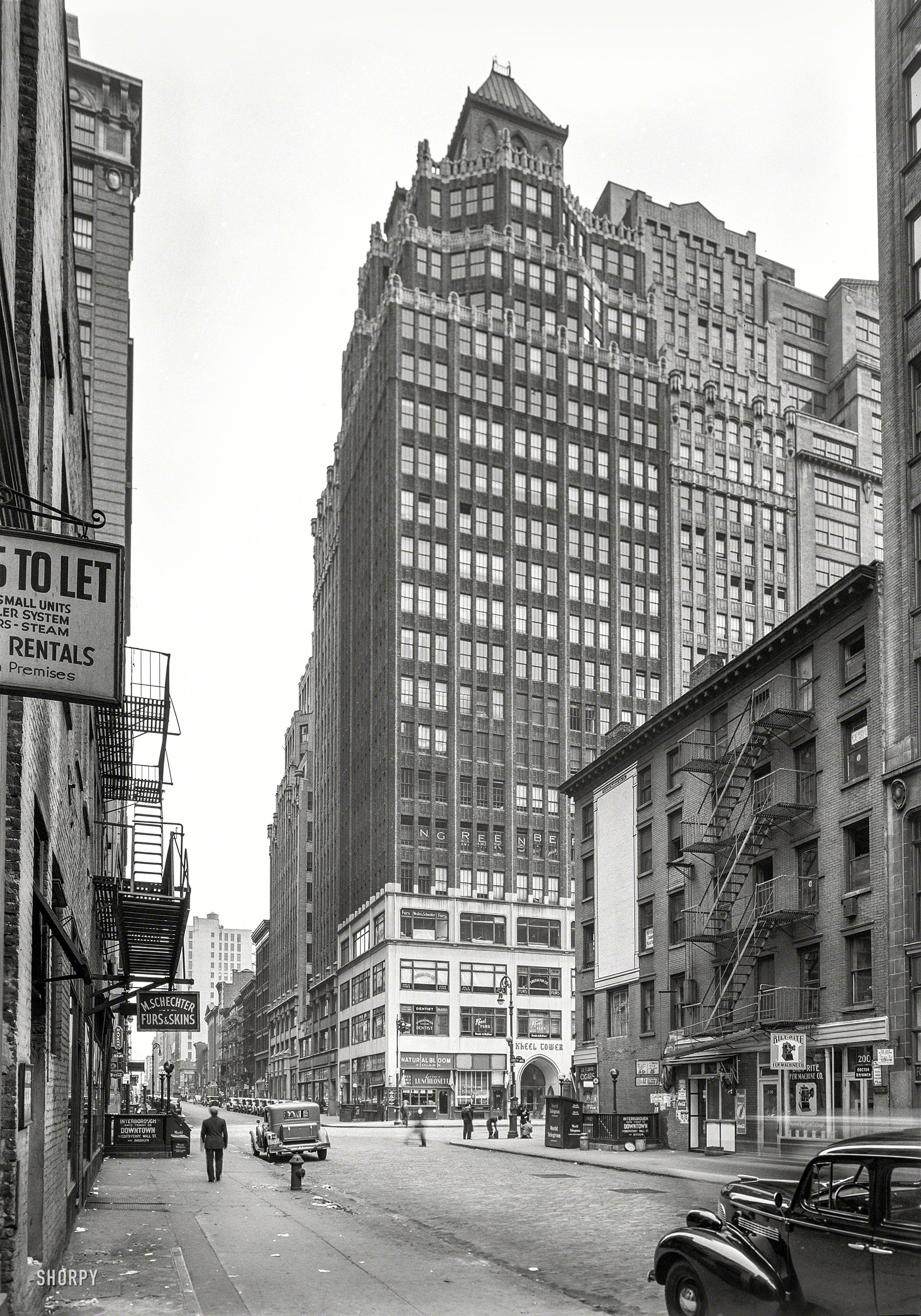 Oct. 8, 1939. "315 Seventh Avenue, New York City. General view." William Hohauser's 1920s skyscraper presides over the fur district, which includes the Bilt-Rite Fur Machine Co. 5x7 negative by Gottscho-Schleisner. View full size.