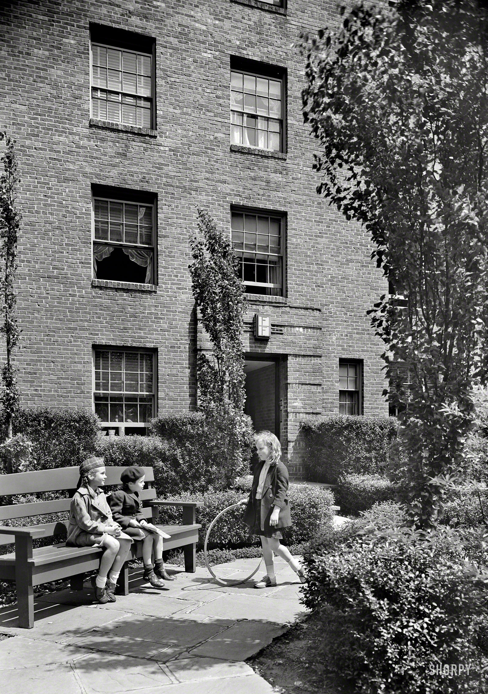 May 17, 1940. "Phipps Garden Apartments, 5101 39th Avenue, Long Island City, New York. Clarence S. Stein, architect." Hanging with a big girl whose feet touch the ground. Large-format negative by Gottscho-Schleisner. View full size.