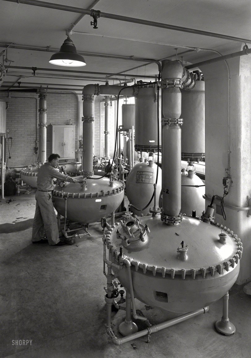 Dec. 17, 1943. "Hoffmann-LaRoche Inc., Nutley, New Jersey. Building 34, three kettles. Pfaudler Co., client." The white rectangles on the tanks are writing that's been blacked out on the negative. Gottscho-Schleisner photo. View full size.
