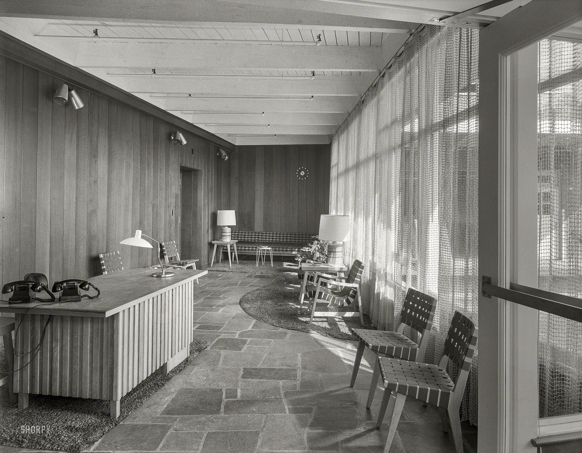 Oct. 12, 1953. "Becton Dickinson, East Rutherford, New Jersey. Reception room to entrance. Fellheimer & Wagner, architect." All this patio needs now is a charcoal grill. Large-format acetate negative by Gottscho-Schleisner. View full size.