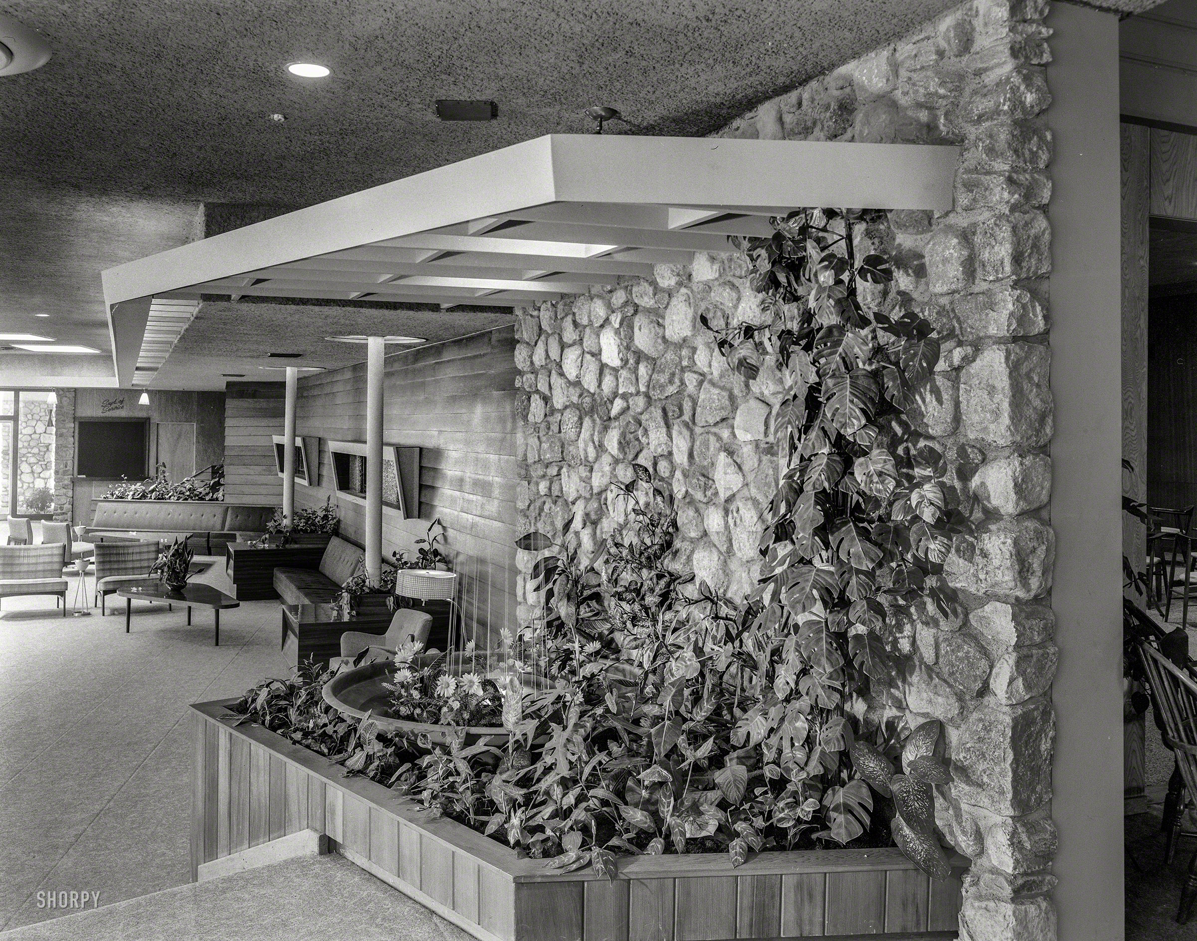 August 13, 1957. "Tamarack Lodge, Greenfield Park, New York. Lobby to fountain." Large-format acetate negative by Gottscho-Schleisner. View full size.