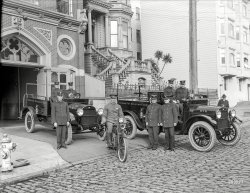 San Francisco, 1921. "Sonora Fire Dept. (Tuolumne County) REO trucks at Engine Company No. 15 firehouse, California Street." Firemen and their machines, and one other guy off to the right. 6½ x 8½ inch glass negative. View full size.