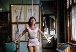February 1956. "Singer-actress Elaine Malbin, who performs in television production as Joan of Arc, in a gym vocalizing while using exercise equipment under the instruction of Joseph Pilates." Color transparency from photos by John Vachon for Look magazine. View full size.