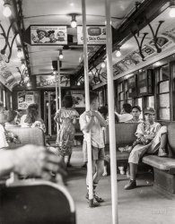June 25, 1949. "When day is done in Brooklyn (boys in advertisement-covered subway car filled with passengers)." Gelatin silver print by Angelo Rizzuto. View full size.
