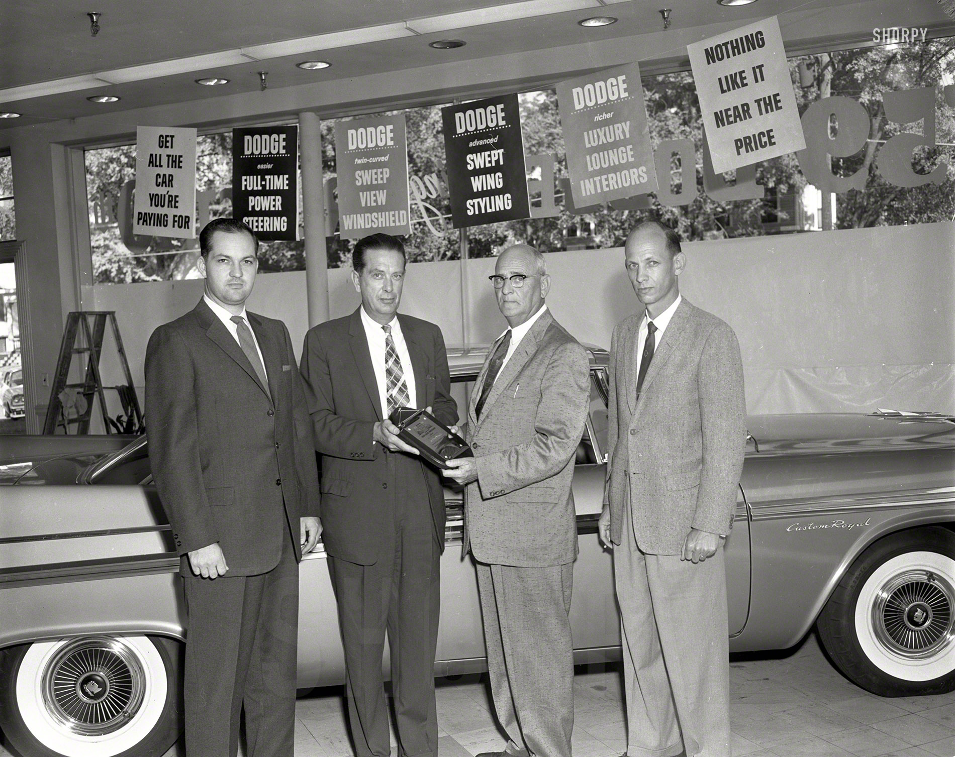 Columbus, Georgia, Dodge dealers in their showroom with one of the last 1958 models, getting ready for the '59s. 4x5 acetate negative. View full size.