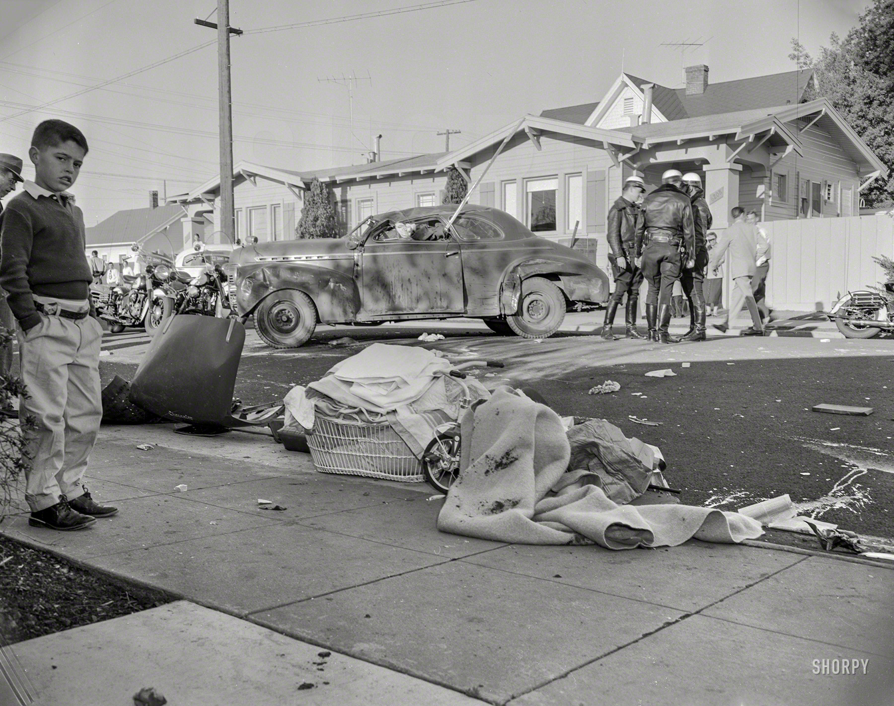 Was Mrs. Smith bringing in the wash when she heard the crash? Circa 1958, more vehicular mayhem in Oakland, California. 4x5 negative. View full size.