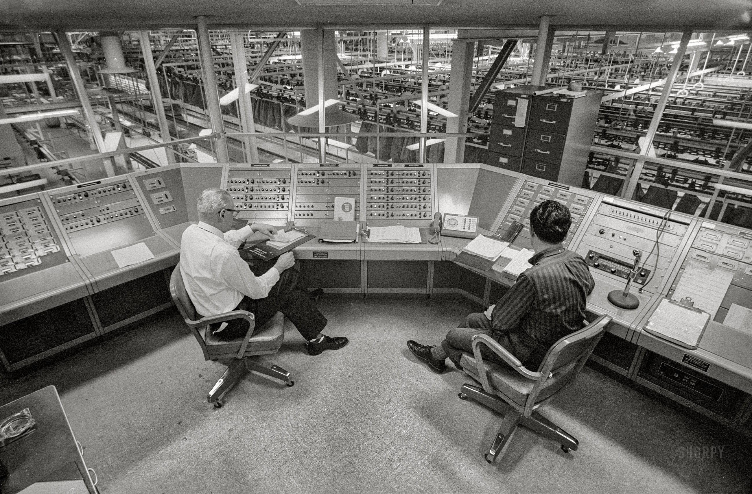 February 7, 1963. Providence, Rhode Island. "Post Office employees sitting at Central Control System overlooking work area." 35mm acetate negative by Thomas J. O'Halloran for the U.S. News & World Report assignment "Automated Post Office." View full size.


1959: "A Post Office Ordered With Full Automation"

&nbsp; &nbsp; &nbsp; &nbsp; WASHINGTON, Feb. 3 -- Orders for the construction of "Project Turnkey," the nation's first fully mechanized Post Office, were given today by Postmaster Arthur E. Summerfield. The office will be built and equipped in Providence, R.I., by Intelex Systems Inc. of New York for an estimated cost of $20 million. Intelex, a subsidiary of International Telephone and Telegraph Corporation, will then lease it to the Post Office Department for twenty years at an annual rental of $1.4 million. The mail will be entirely handled by machinery ... " (N.Y. Times, Feb. 4, 1959)

1961: "House Group Finds Automated P.O. 'Fails Miserably' "

&nbsp; &nbsp; &nbsp; &nbsp; A House subcommittee charged yesterday that Project Turnkey, the new automated post office in Providence, R.I., has "failed miserably" to meet expectations and that its cost to the Government appears to be "grossly excessive." (Washington Post, March 2, 1961)