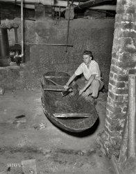 From circa 1950s Columbus, Georgia, comes this uncaptioned News Archive negative of a young man and his dugout, evidently crafted in the basement. Ready to open that spigot and float off to points unknown. View full size.