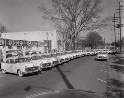Columbus, Ga., circa 1952. "Radio Cab Co." A fleet of two-door taxis -- Ford Mainline Tudor Sedans. 4x5 negative from the News Archive. View full size.