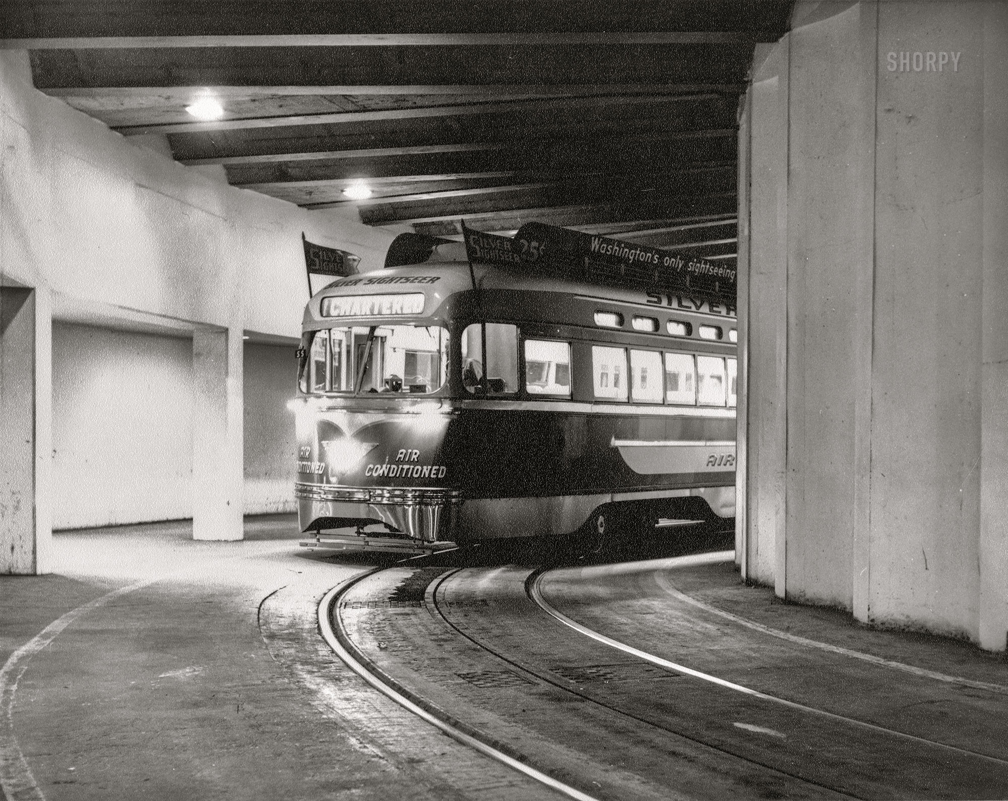 August 22, 1961. Washington, D.C. "Silver Sightseer, D.C. Transit air-conditioned trolley, in tunnel under the U.S. Bureau of Engraving and Printing building." 8x10 inch gelatin silver print by railroad historian Ara Mesrobian (1924-2019). View full size.