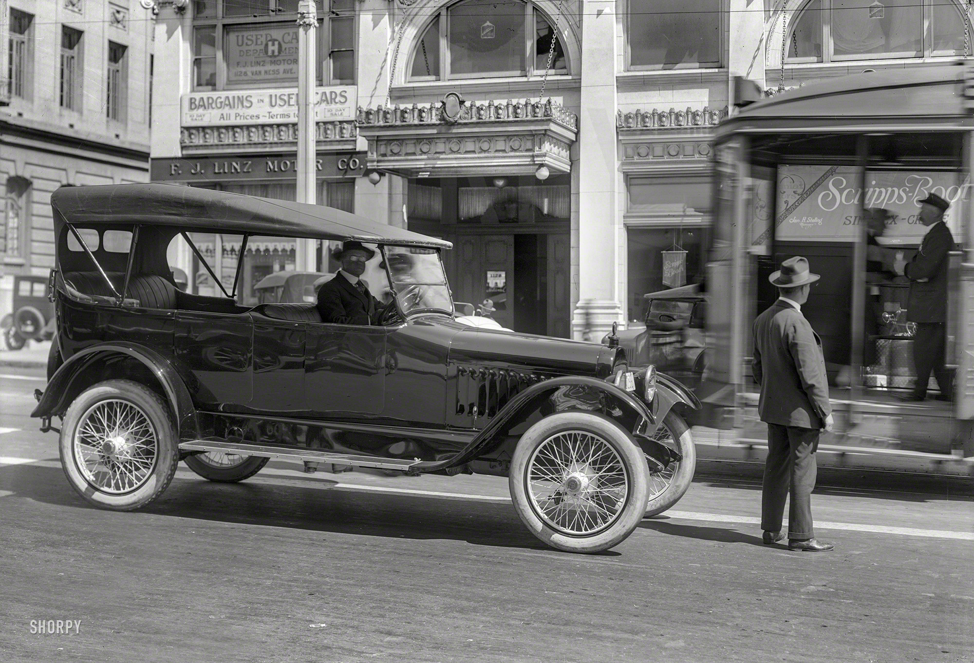 San Francisco circa 1920. "Chalmers touring car on Van Ness Avenue." At F.J. Linz Motor Co., your Scripps-Booth dealer. With a streetcar squeezing by.  5x7 glass negative by Christopher Helin. View full size.