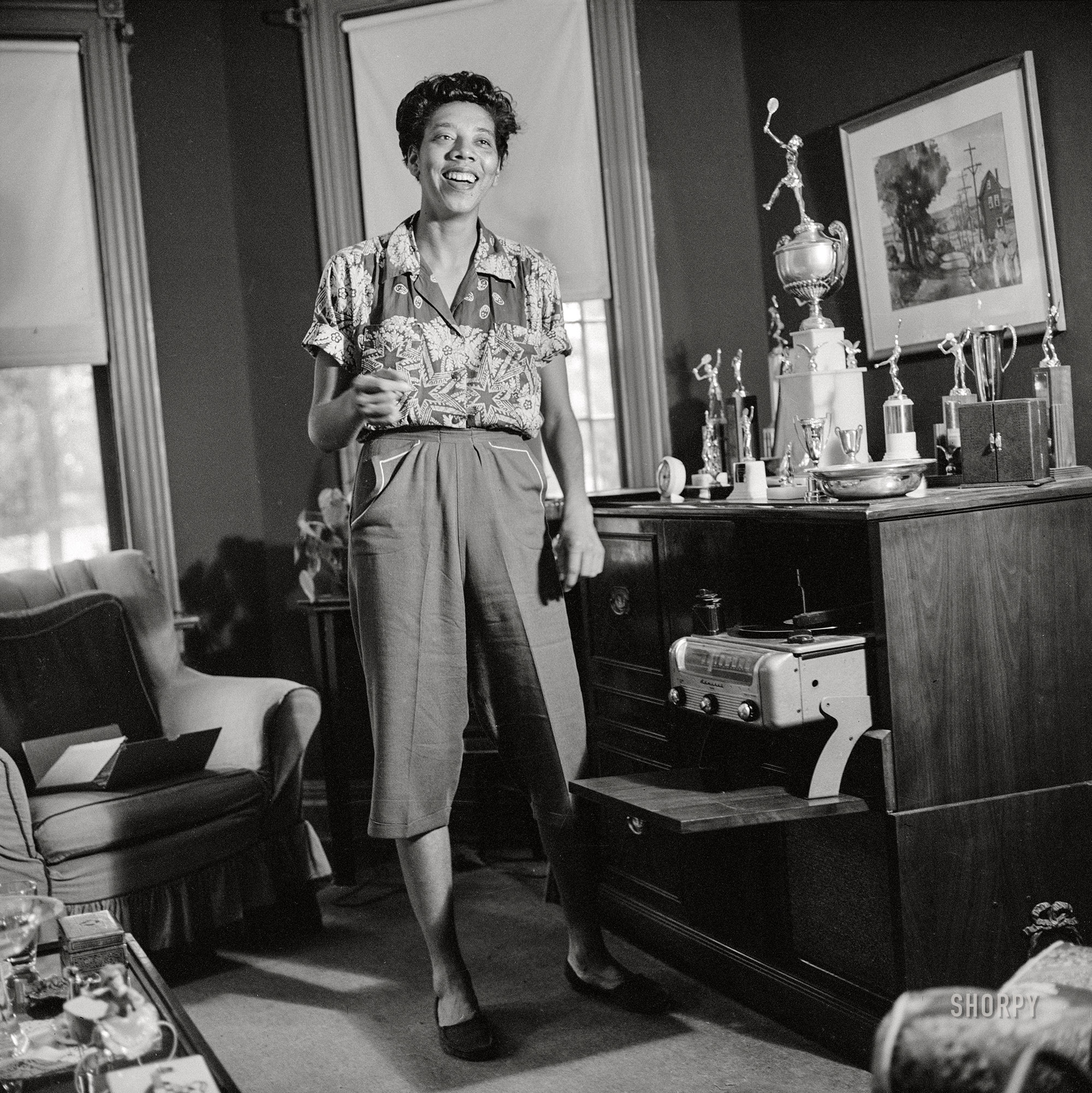 September 1957. New York. "Tennis champion Althea Gibson unpacking trophies at her home in Harlem." Medium format acetate negative by Genevieve Naylor for the Look magazine assignment "Althea Gibson: Tragic Success Story." View full size.