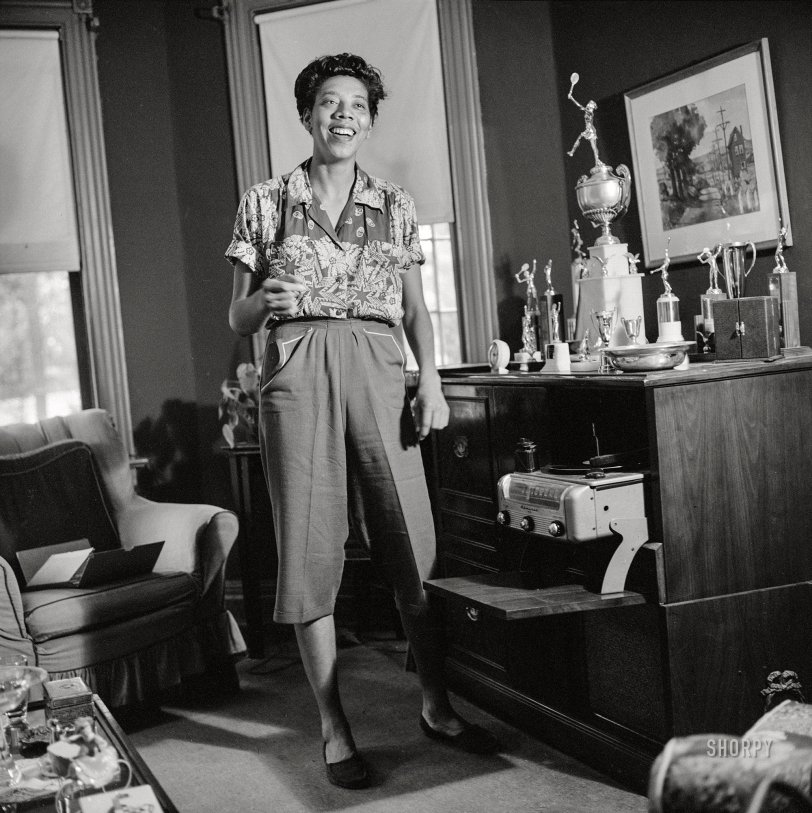September 1957. New York. "Tennis champion Althea Gibson unpacking trophies at her home in Harlem." Medium format acetate negative by Genevieve Naylor for the Look magazine assignment "Althea Gibson: Tragic Success Story." View full size.
