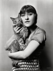 1916. "Dolly sister with Buzzer the cat, portrait photograph." One of the Dolly Sisters (Rose and Jenny), twin vaudeville stars from Budapest who made it big in America. 5x7 nitrate negative by Arnold Genthe. View full size.